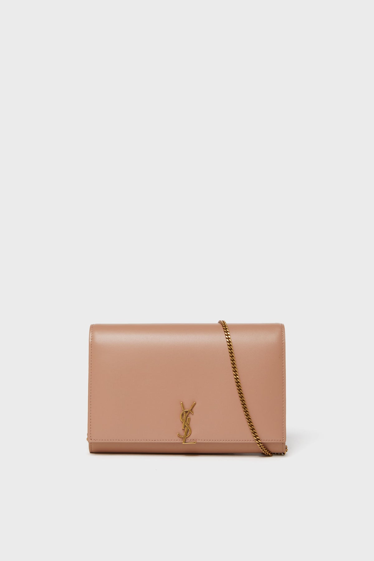 A nude pink Tuckernuck Archive Collection Wallet on Chain with a gold chain strap and logo accent, showcasing timeless elegance.