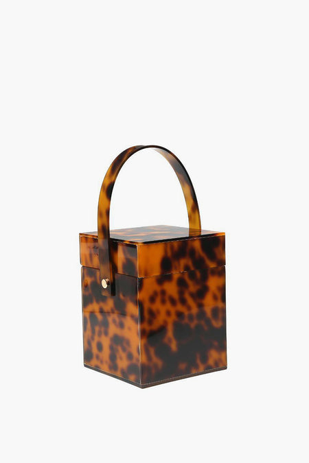 Urban Expressions square box clutch features a vintage tortoiseshell pattern, top handle, and durable acrylic construction.