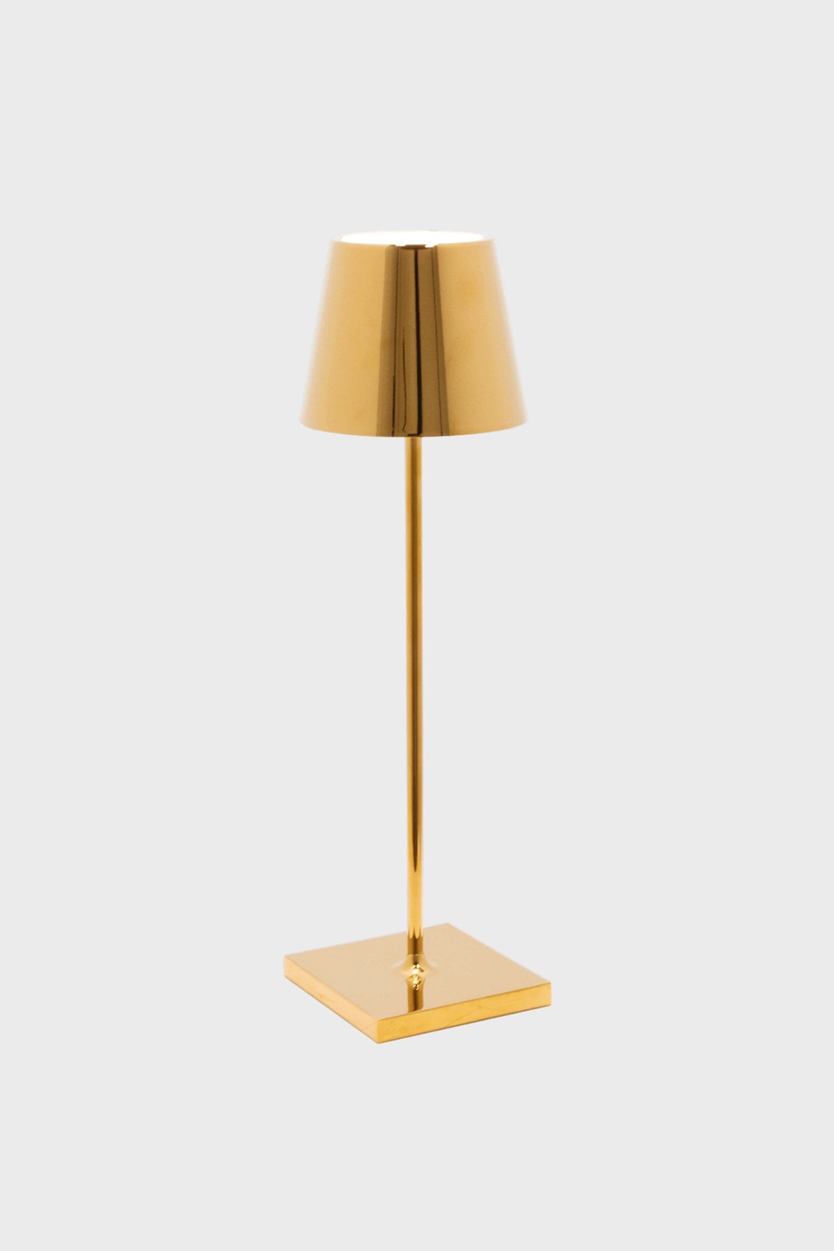 The Zafferano gold cordless LED table lamp, with its cylindrical stem, square base, and cone-shaped shade, brings sleek elegance to any space.