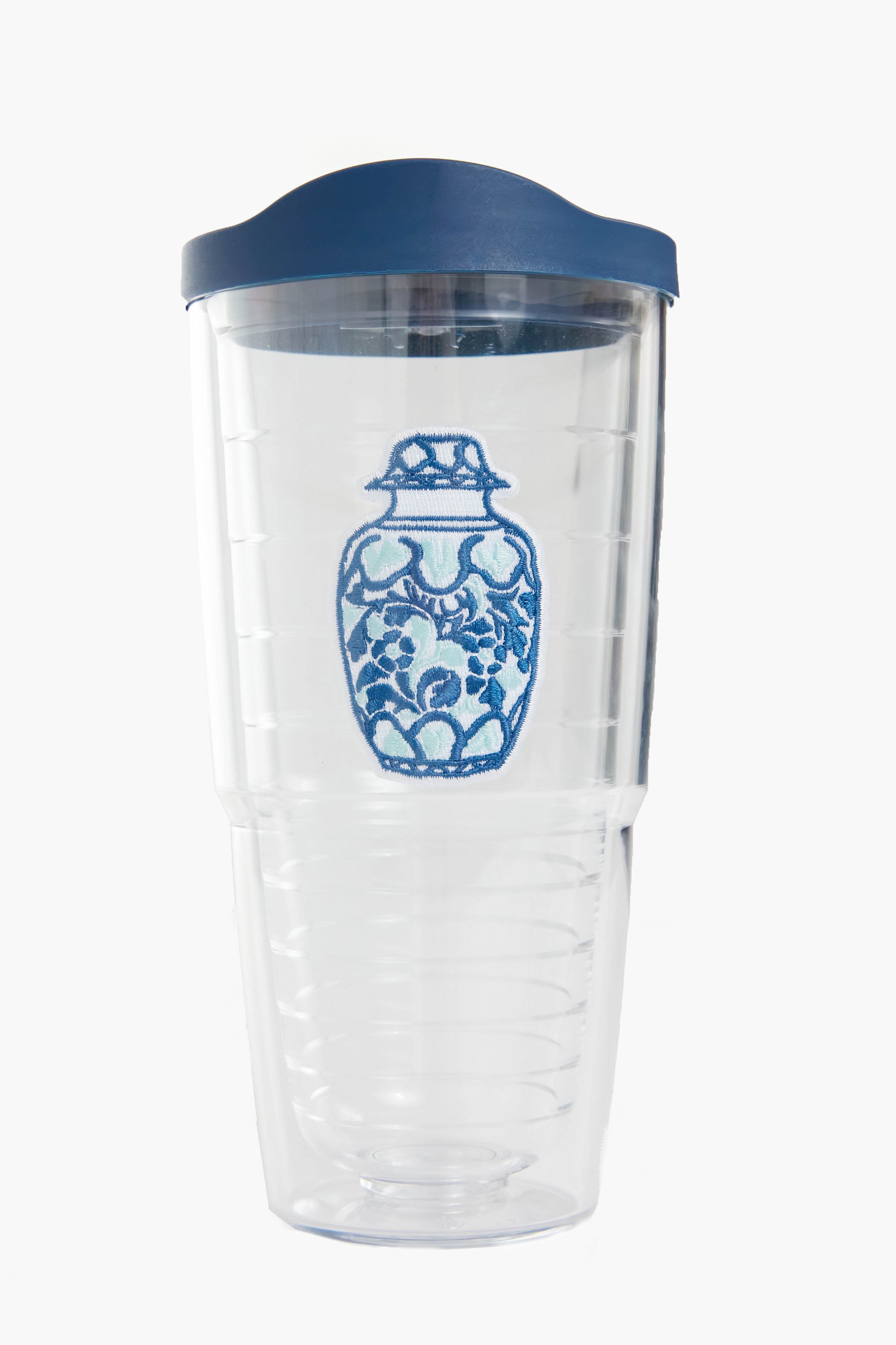 The Tervis Tumbler x Tuckernuck features a blue and white decorative vase design, clear plastic body, blue lid, is BPA-free, and has double-wall insulation to keep drinks hot or cold.