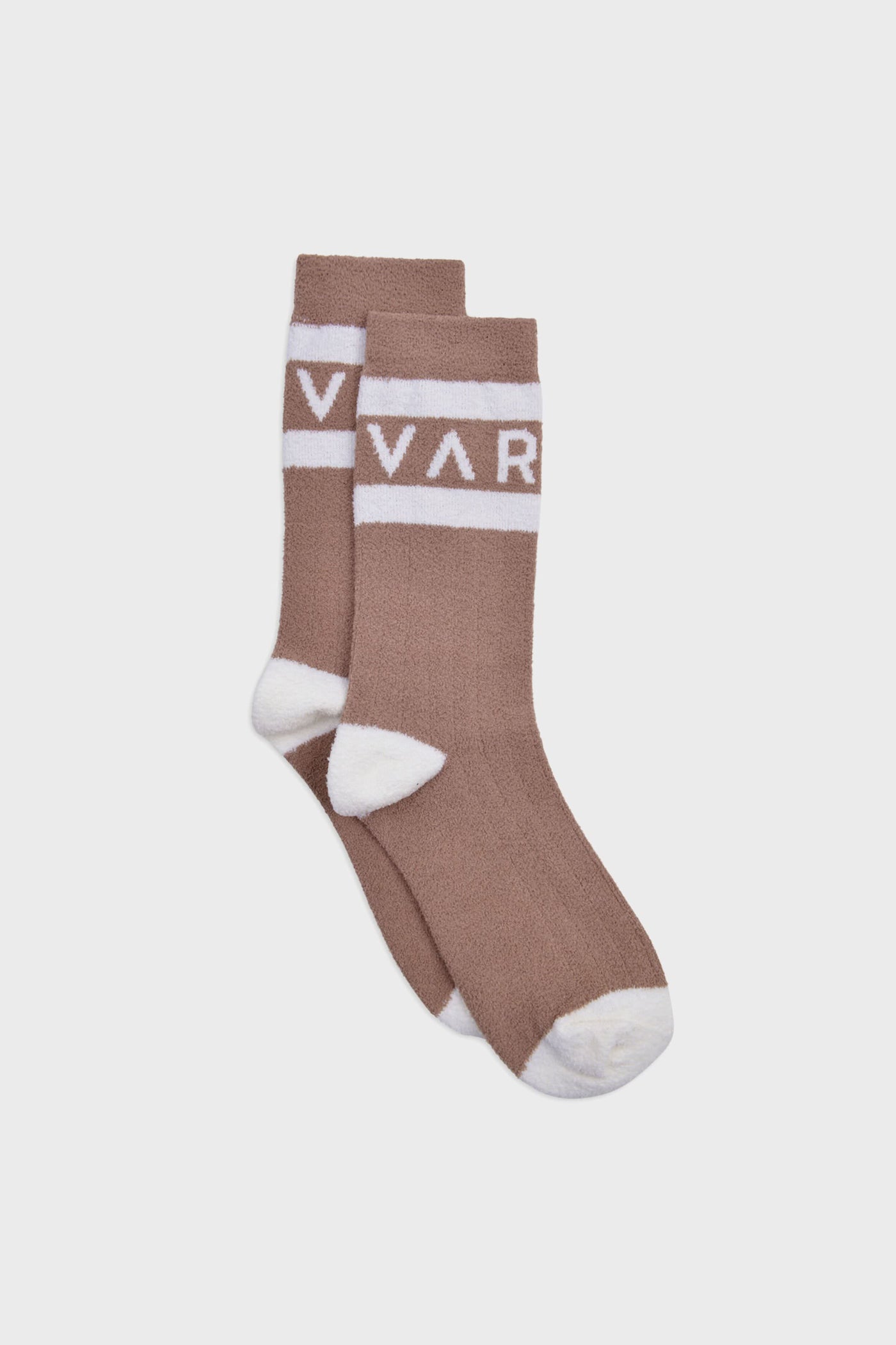 A pair of brown boucle crew socks by Varley with white toes, heels, and cuffs, featuring a white band near the top with "VAR" text.