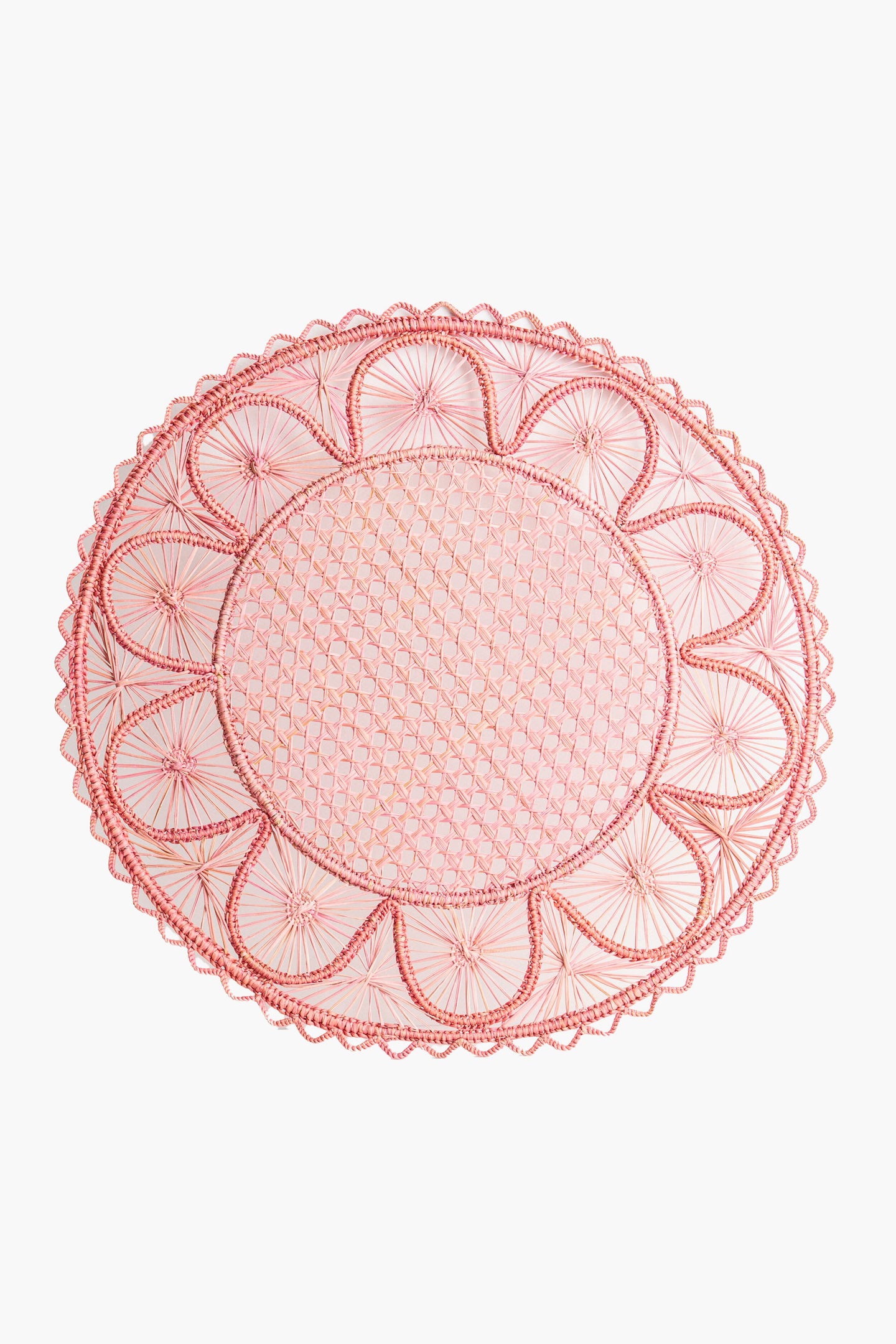 The Coro Cora pink oval lace doily features an intricate geometric pattern and scalloped edges, ideal as a handmade placemat or artisan table accessory.