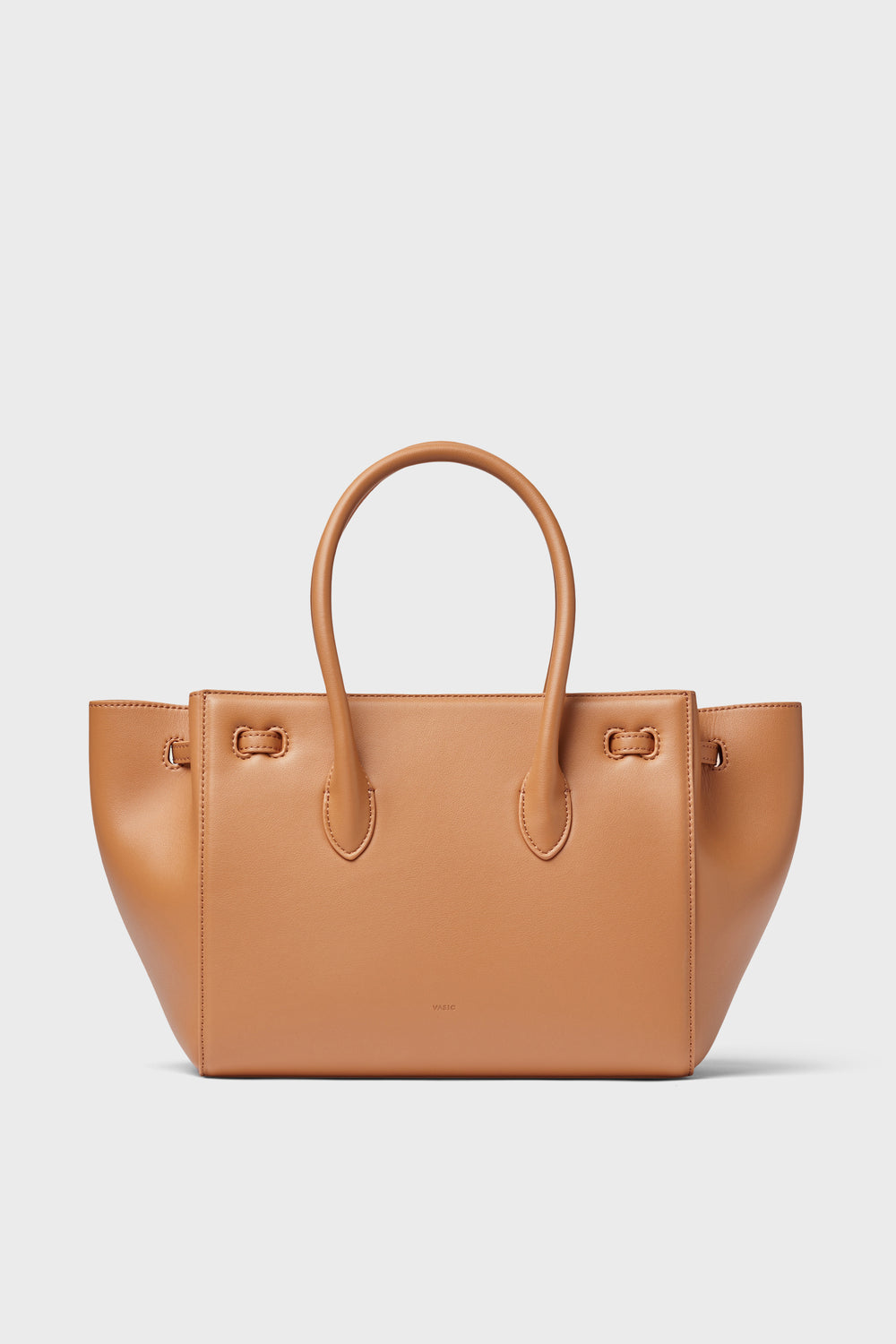 The Vasic mini handbag, featuring a handle and stylish brown design, is perfect for everyday use.