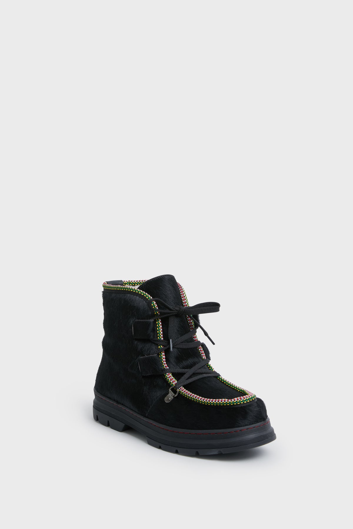 The Penelope Chilvers ankle boot features a textured black surface, multicolored trim, black laces, and a thick sole—perfect as cozy shearling-lined après ski footwear.