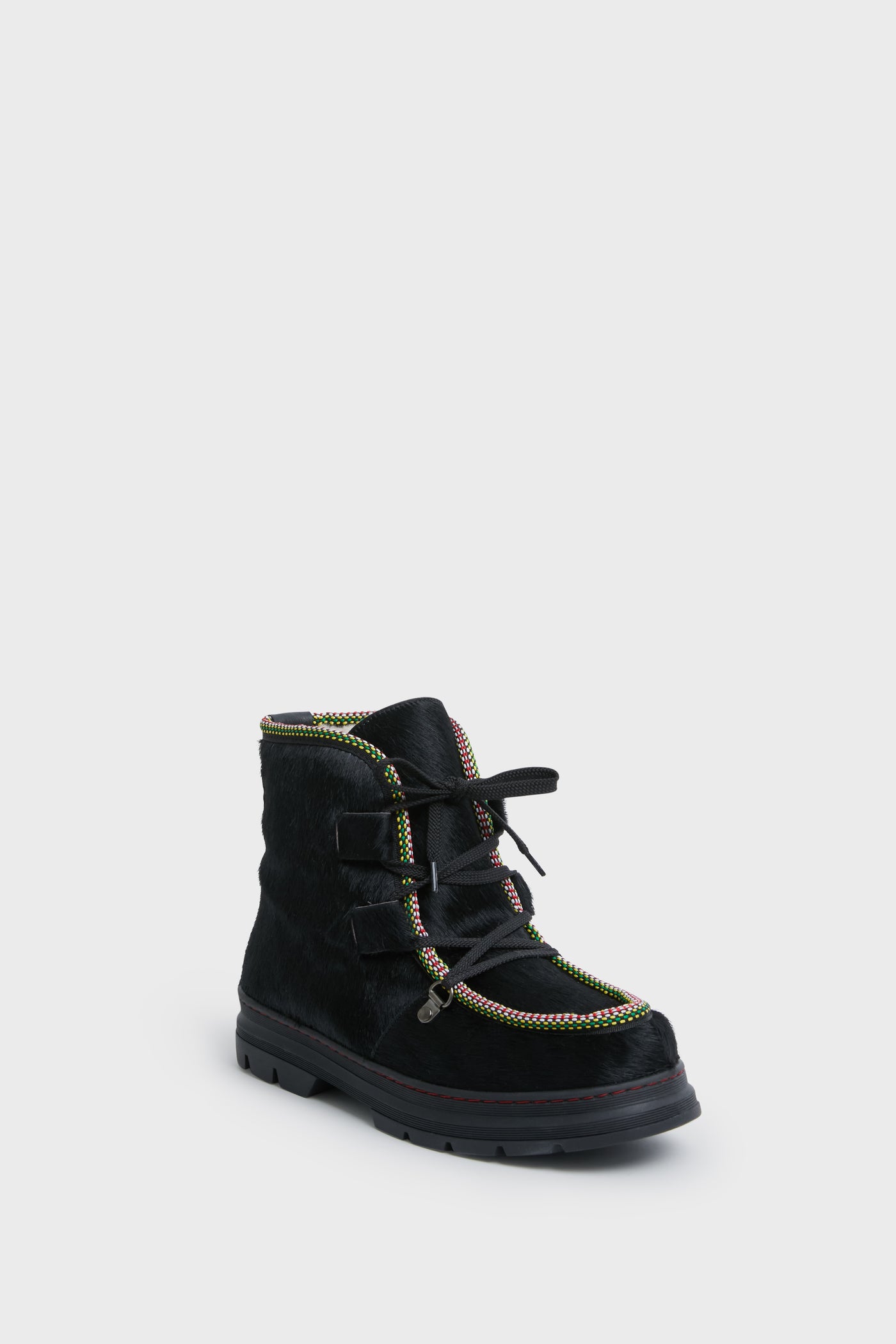 The Penelope Chilvers ankle boot features a textured black surface, multicolored trim, black laces, and a thick sole—perfect as cozy shearling-lined après ski footwear.