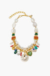 Lizzie Fortunato gold-plated brass chain necklace featuring irregular freshwater pearls, colorful gemstone beads, orange discs, a green heart charm, circular shell, gold accents, and assorted charms in the brand’s signature style.