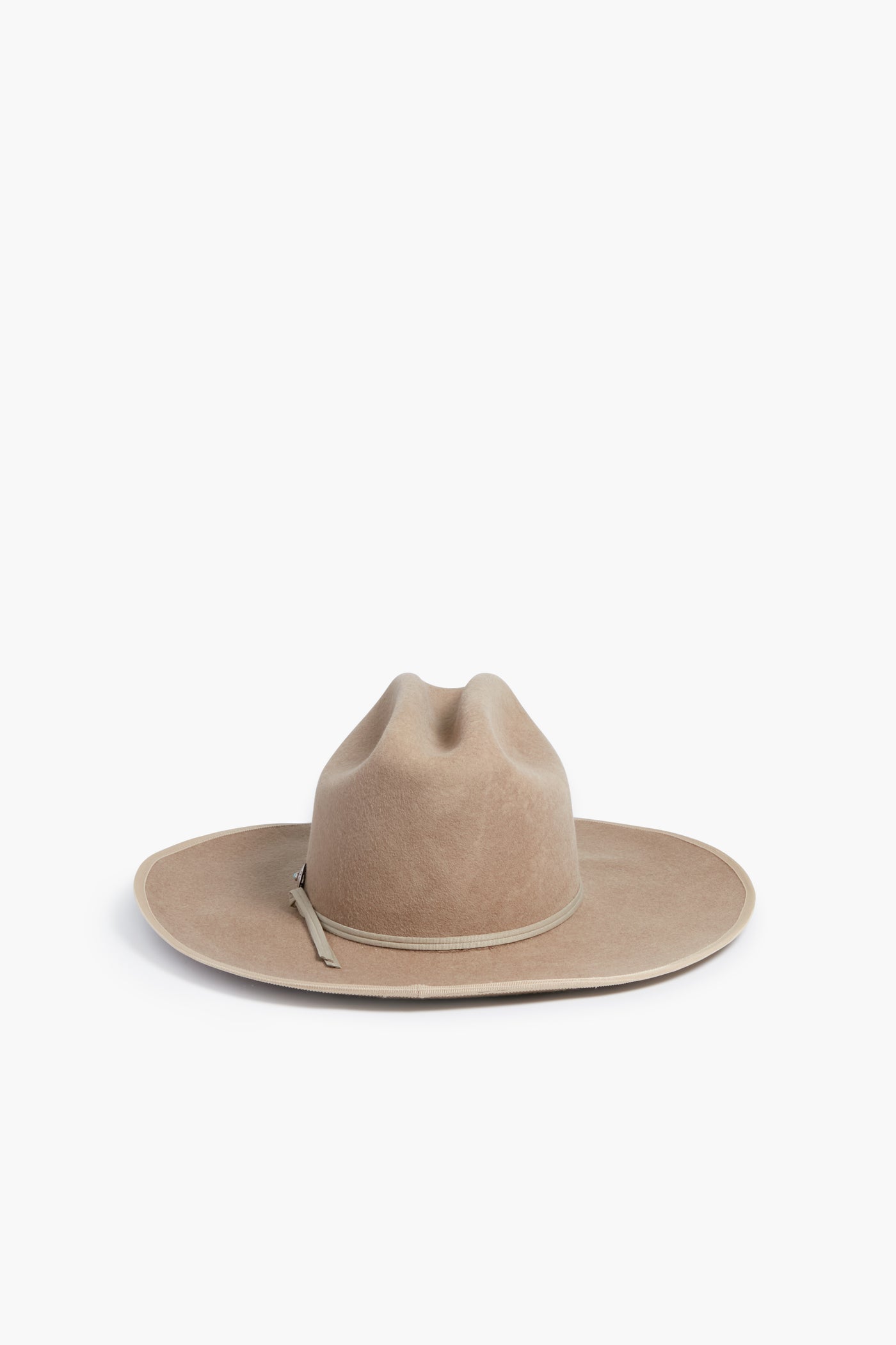 The Hampui Hats wide-brimmed beige felt Western hat features a creased crown and slim decorative band—perfect for anyone who values custom-made headwear.