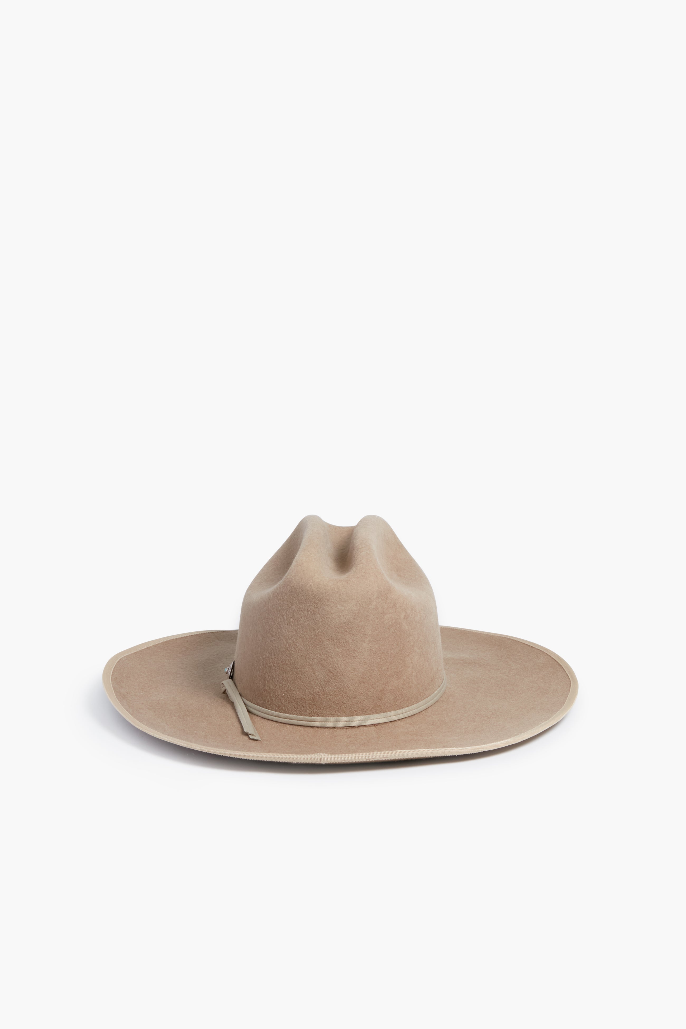 The Hampui Hats wide-brimmed beige felt Western hat features a creased crown and slim decorative band—perfect for anyone who values custom-made headwear.