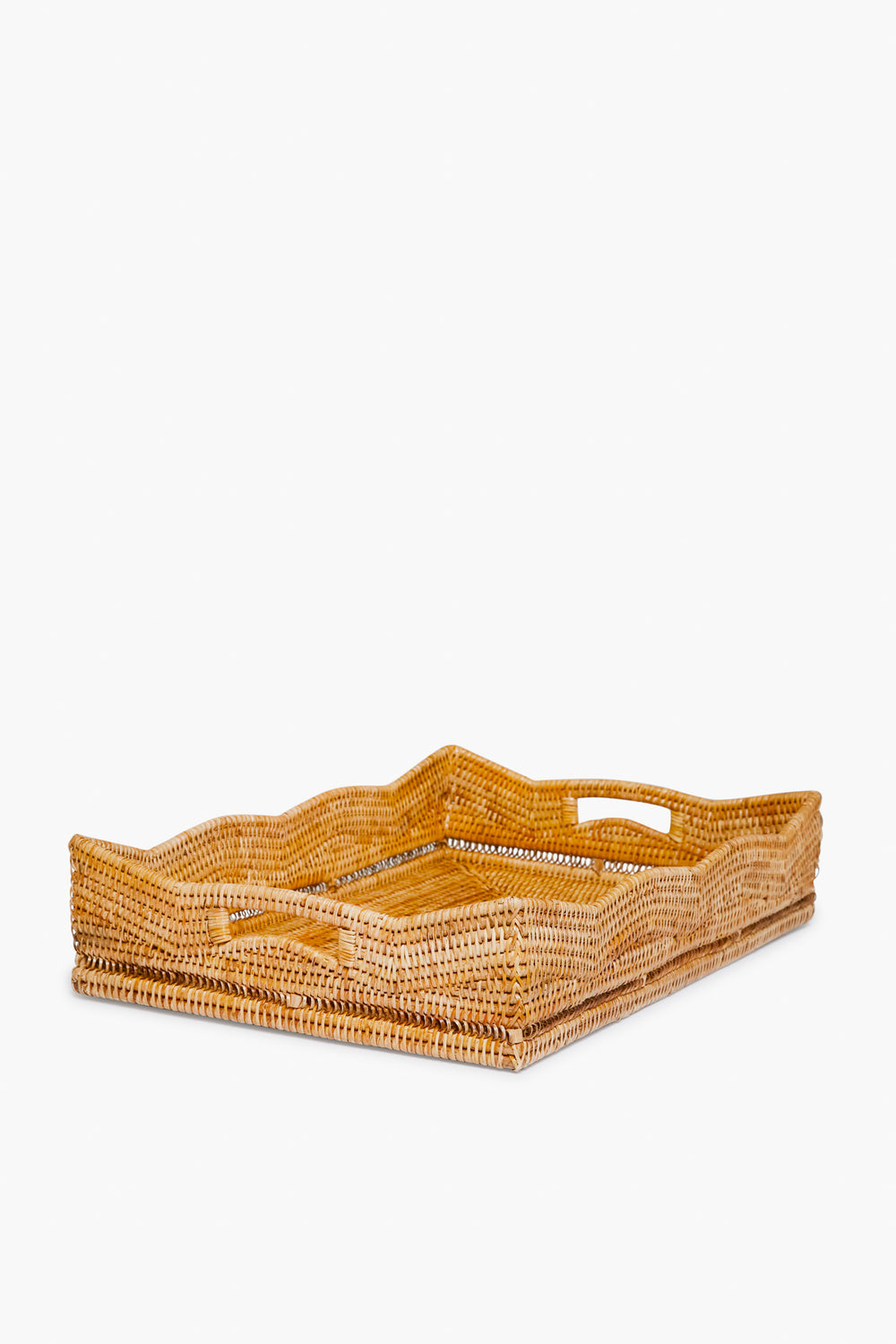 Artifacts Trading Company’s rectangular hand woven rattan tray features raised sides and built-in handles, making it a perfect choice for sustainable home decor.