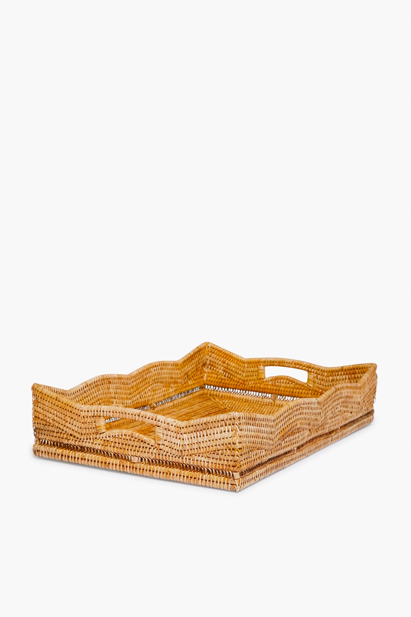 Artifacts Trading Company’s rectangular hand woven rattan tray features raised sides and built-in handles, making it a perfect choice for sustainable home decor.