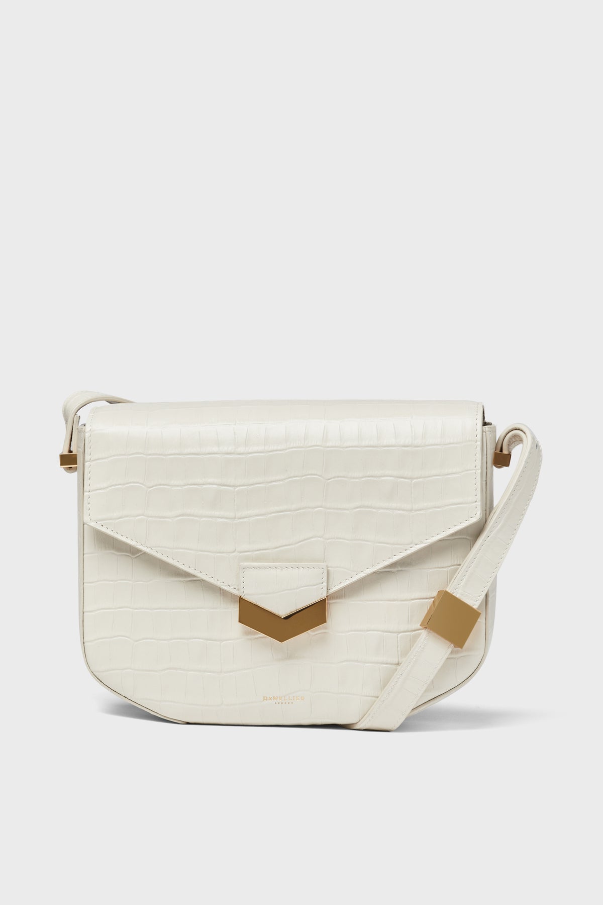 The Demellier white crocodile-embossed leather shoulder bag features a front flap, gold-tone hardware, and an adjustable strap—a versatile handcrafted crossbody that showcases timeless elegance.