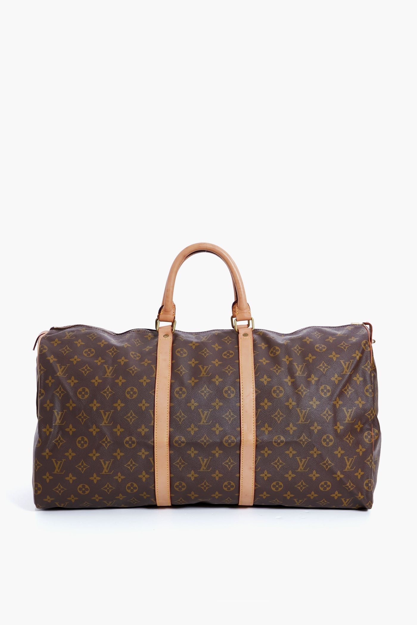 A brown Tuckernuck Archive Collection duffle bag with tan leather handles and accents, crafted from signature monogram canvas—a stylish luxury travel piece.