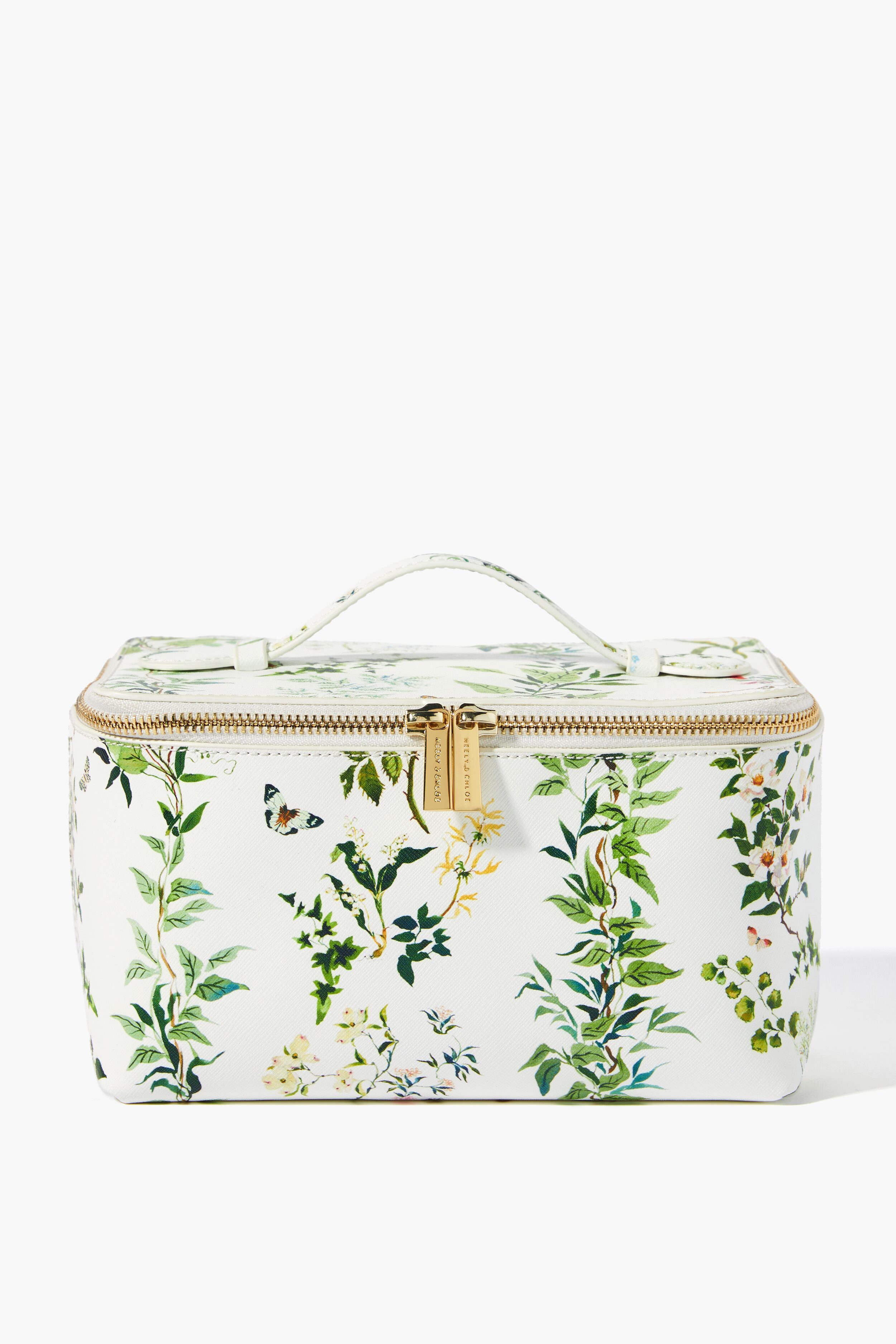 Neely & Chloe x Inslee rectangular vanity case in white saffiano leather with a gold zipper, top handle, and a green botanical floral pattern—an ideal holiday gift.