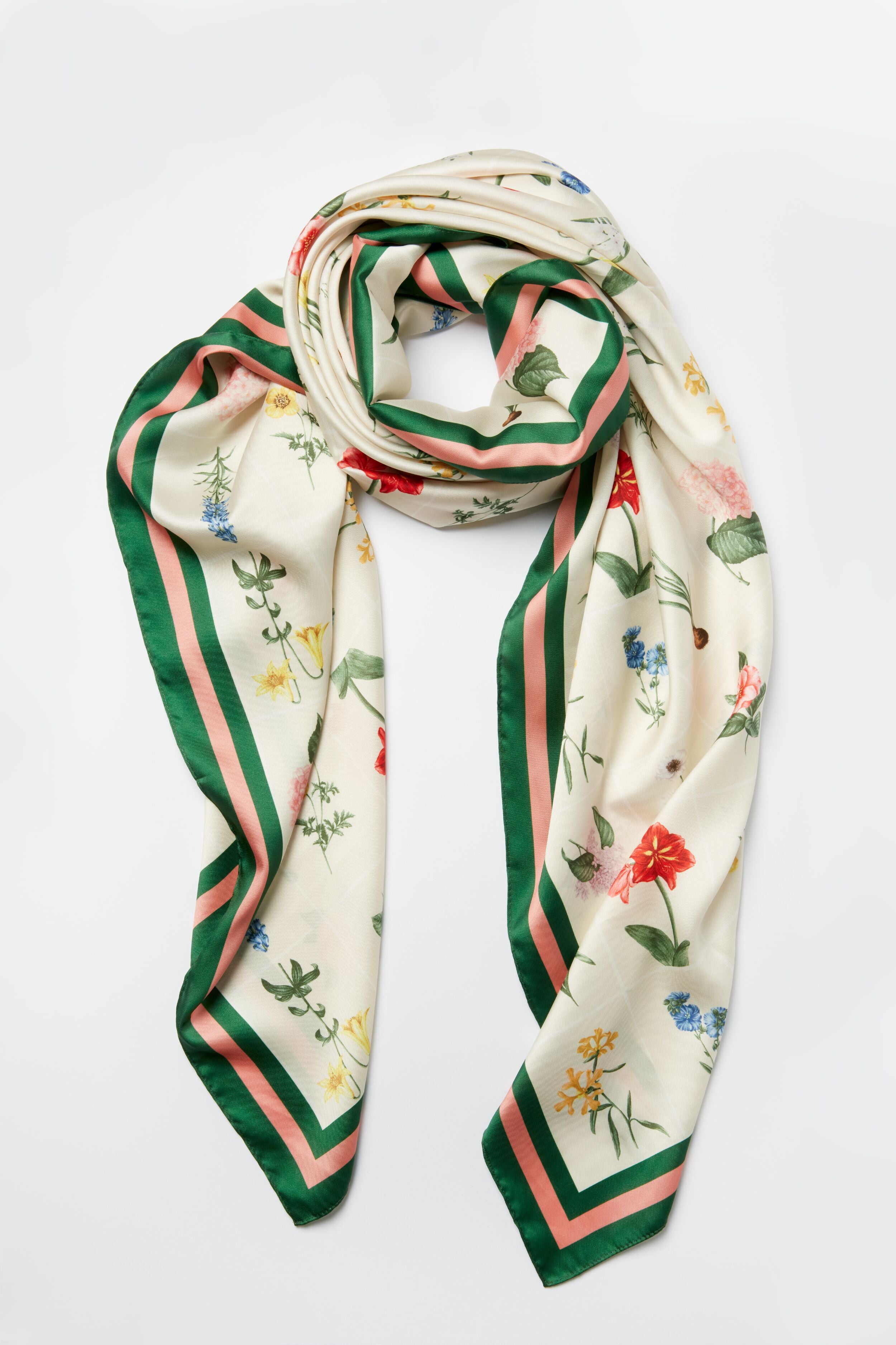 Tuckernuck Accessories' cream silk floral scarf features a custom print and green and pink striped border, making it a perfect luxury accessory.