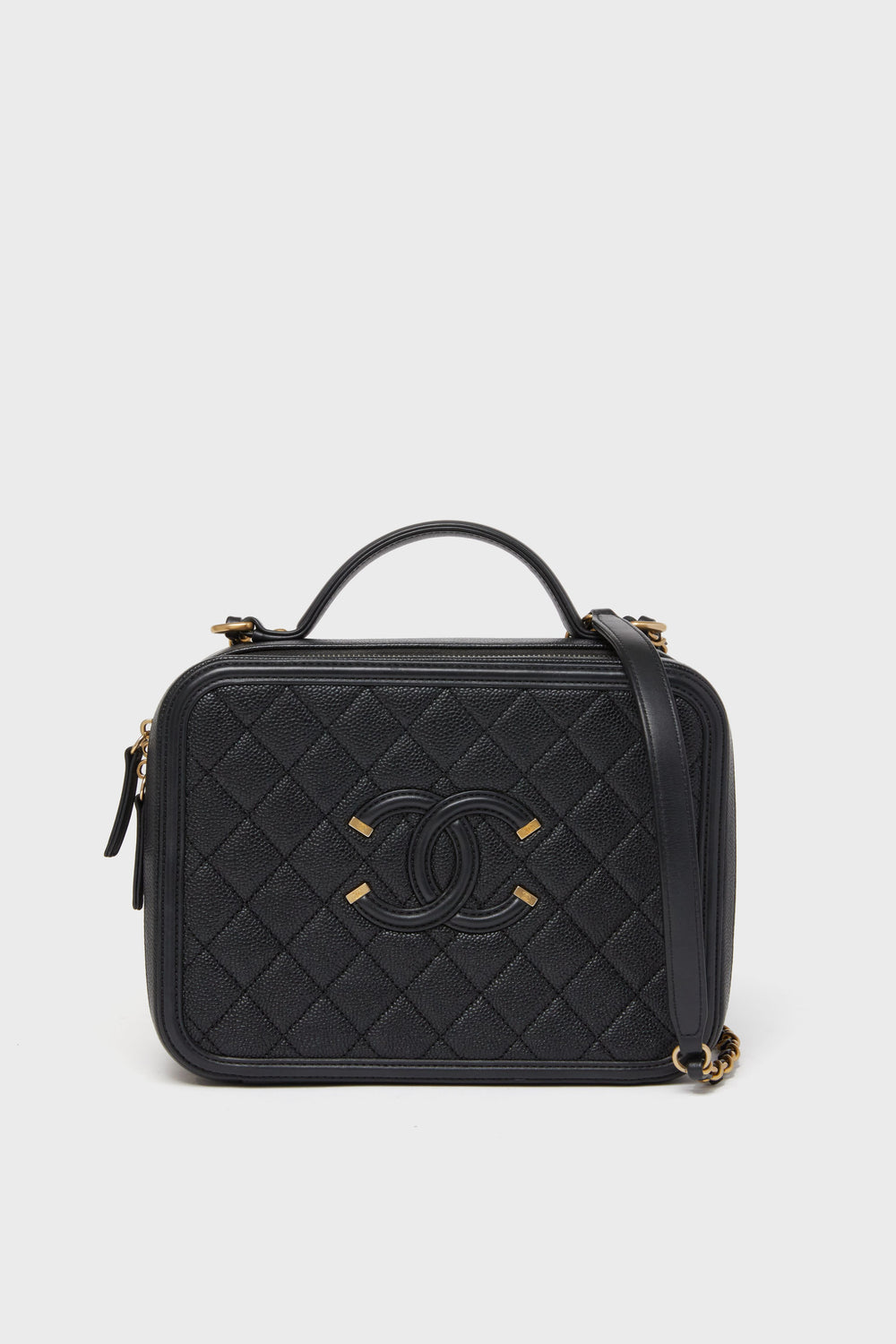 A Tuckernuck Archive Collection Classic Flap Bag in black quilted leather features a top handle, gold hardware, and the iconic front logo.