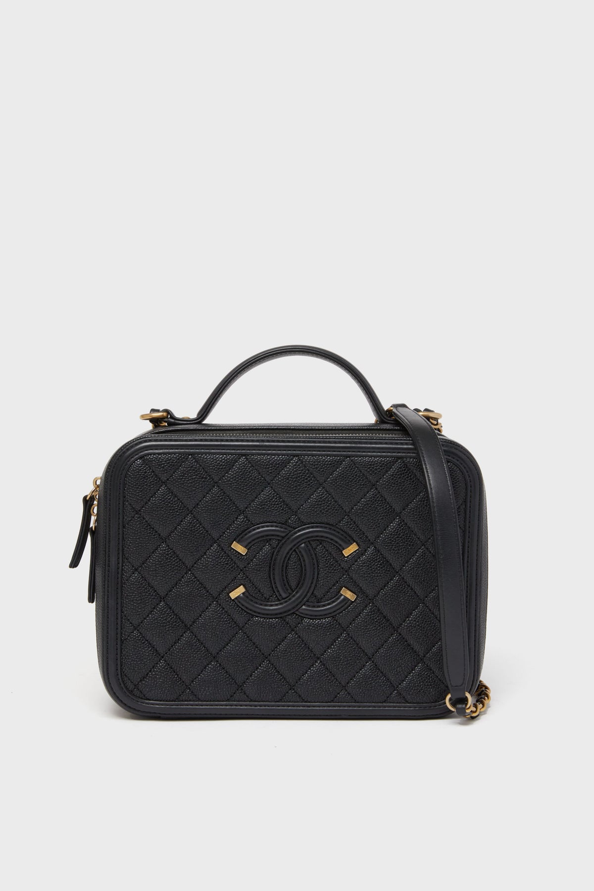 A Tuckernuck Archive Collection Classic Flap Bag in black quilted leather features a top handle, gold hardware, and the iconic front logo.