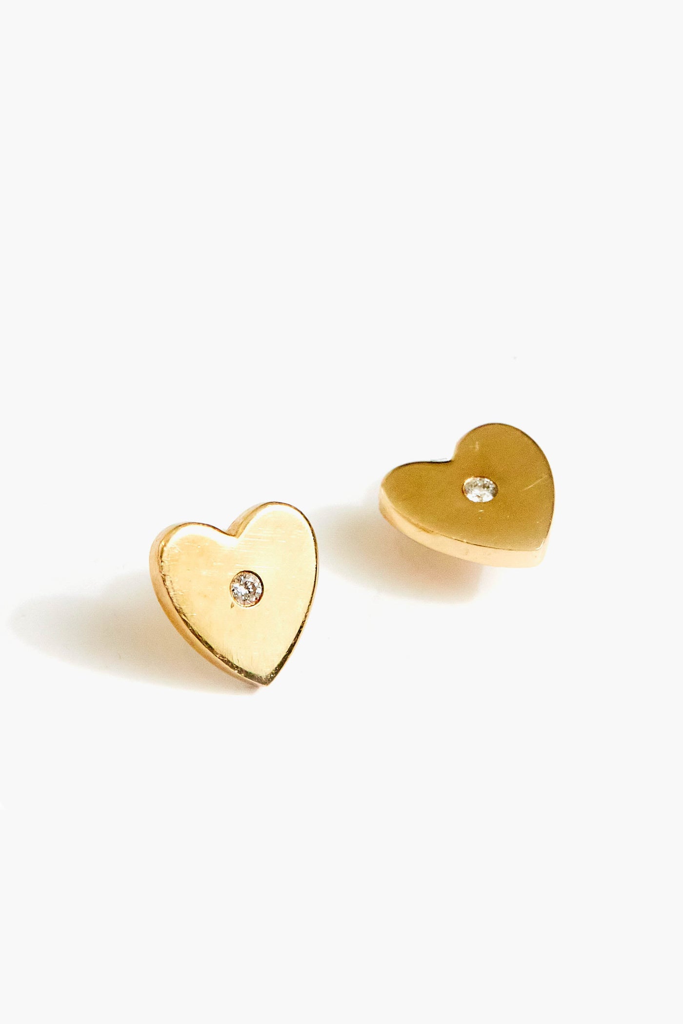 Theodosia 14k gold heart studs each feature a small clear gemstone at the center—elegant fine jewelry that brings classic sparkle to any look.