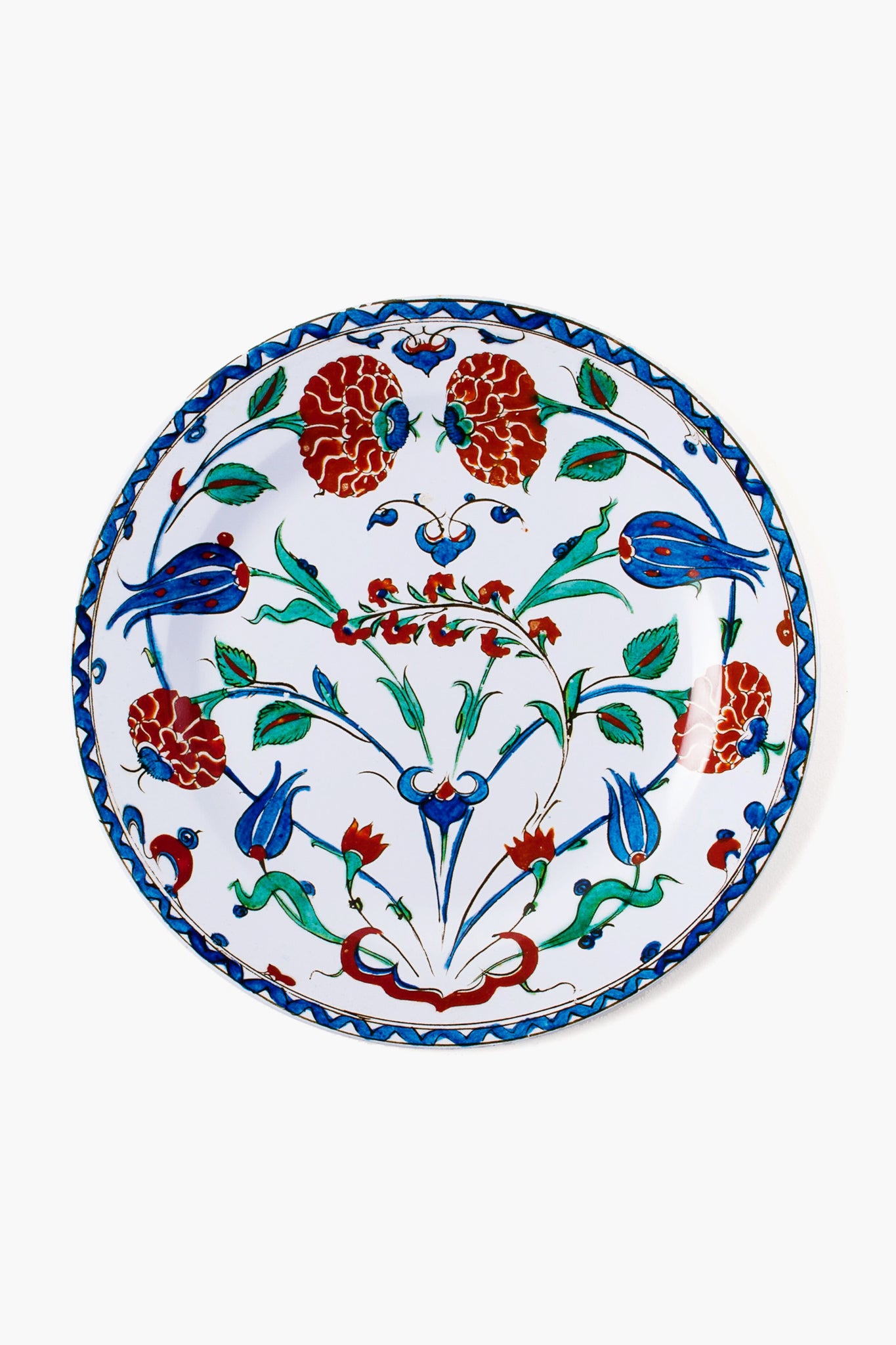 A decorative tin plate by One Hundred 80 Degrees features a floral and bird motif in red, blue, and green with intricate patterns. This easy-to-clean tableware adds charm and elegance to your dining experience.