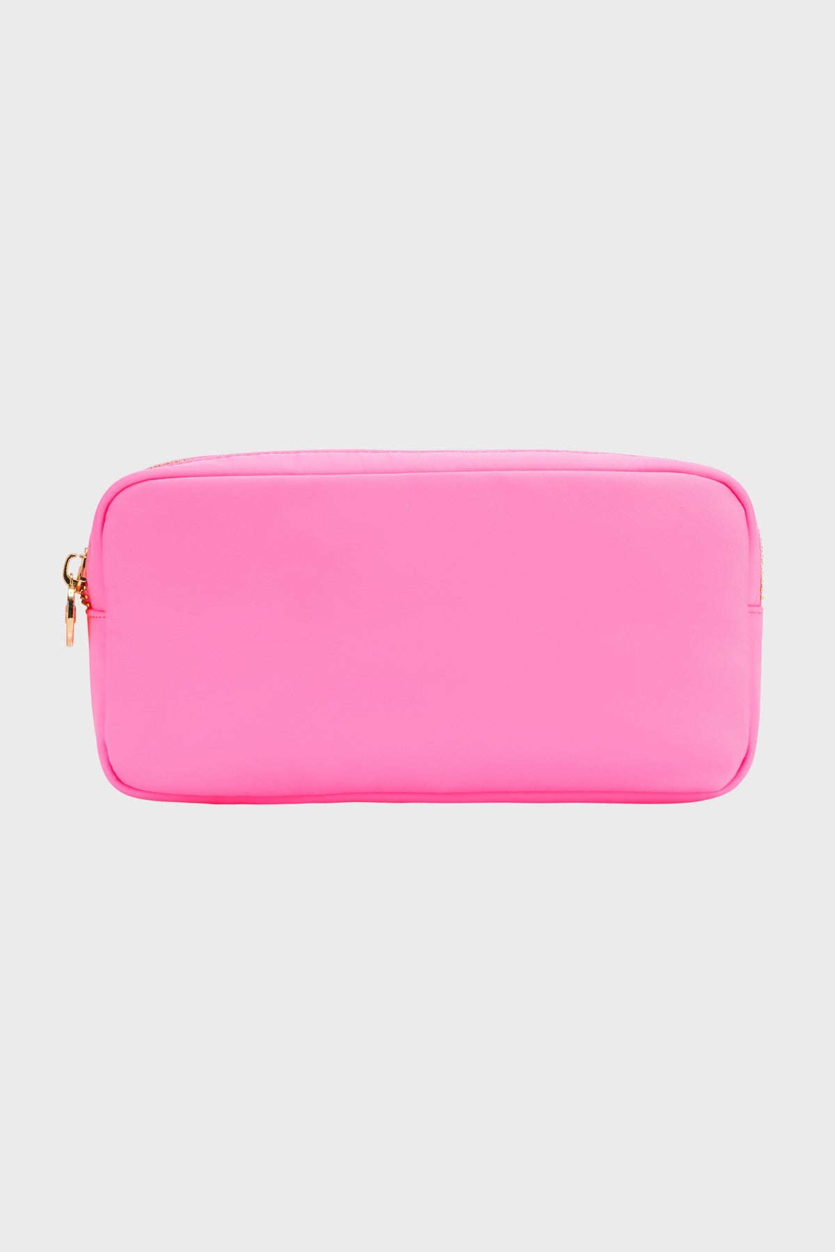 The Stoney Clover Lane small rectangular pouch in bright pink features a gold zipper, making it a stylish travel accessory or makeup case.