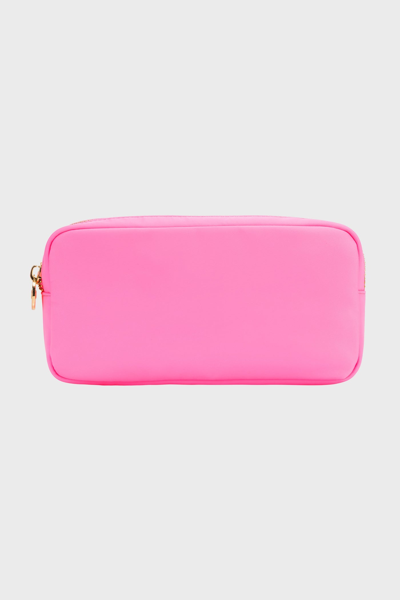 The Stoney Clover Lane small rectangular pouch in bright pink features a gold zipper, making it a stylish travel accessory or makeup case.