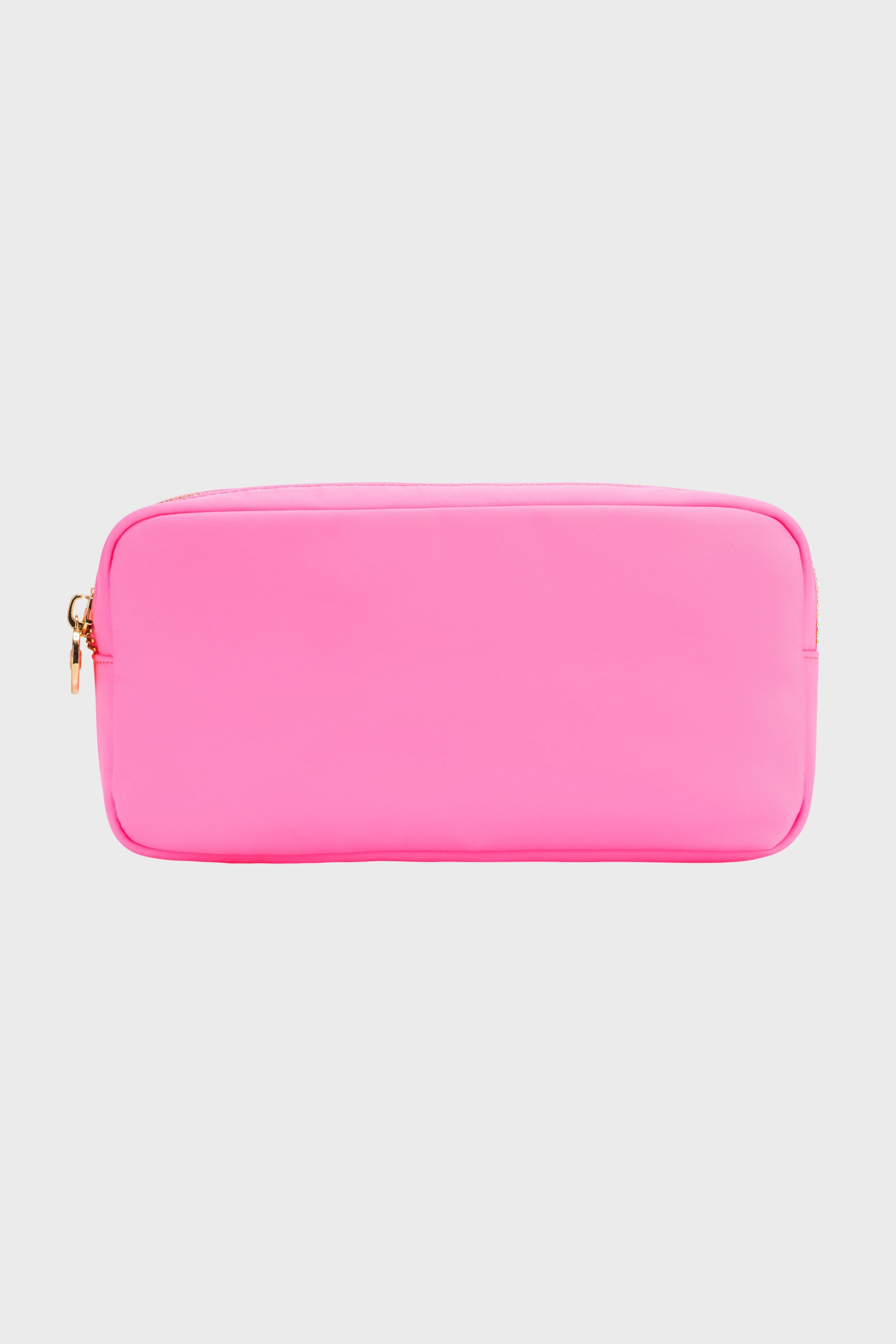 The Stoney Clover Lane small rectangular pouch in bright pink features a gold zipper, making it a stylish travel accessory or makeup case.