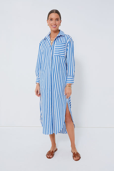 A woman wears a Pomander Place blue and white striped shirt dress with a side slit, brown sandals, and a stylish maxi length.