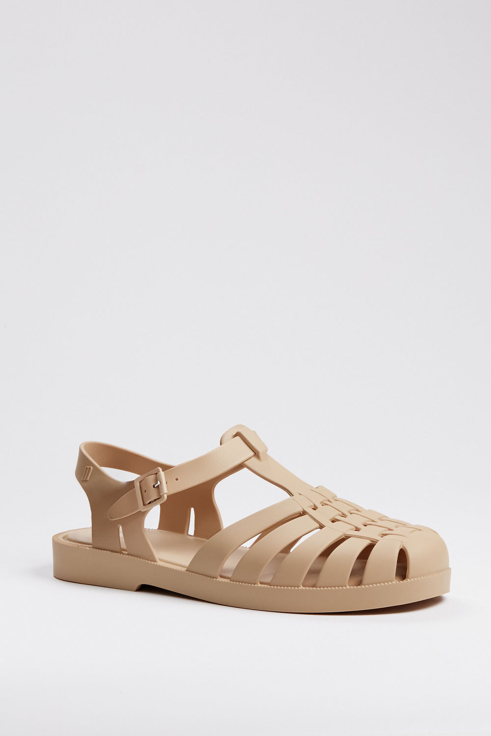 Melissa beige jelly sandal with closed toe, woven design, adjustable buckle strap, and flat sole—a stylish and iconic choice for sustainable fashion enthusiasts.