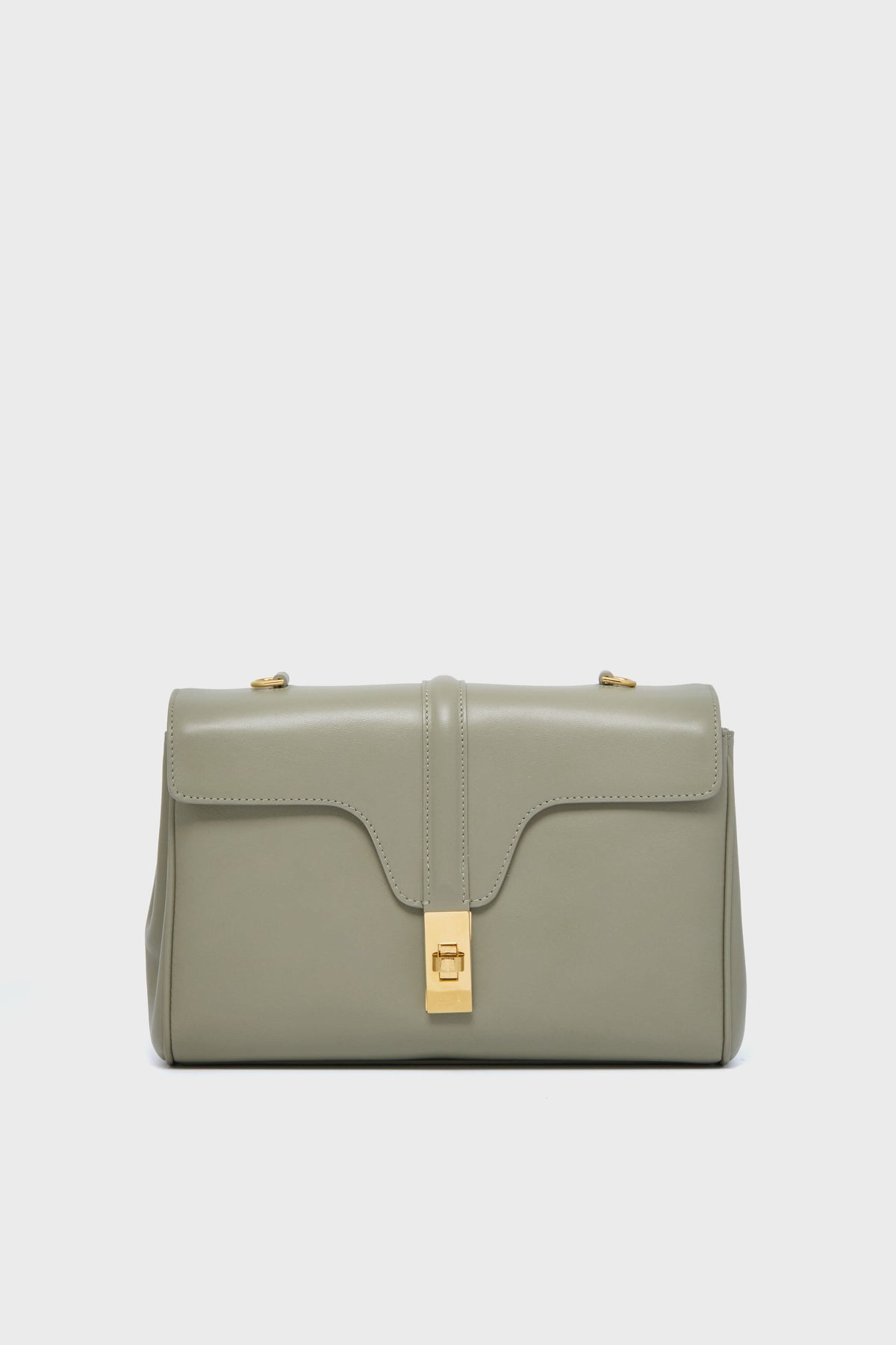 A rectangular, light gray luxury leather handbag from the Tuckernuck Archive Collection, featuring a flap closure and gold-tone hardware—central clasp and two top studs—reminiscent of the Celine Teen Soft 16 Bag.