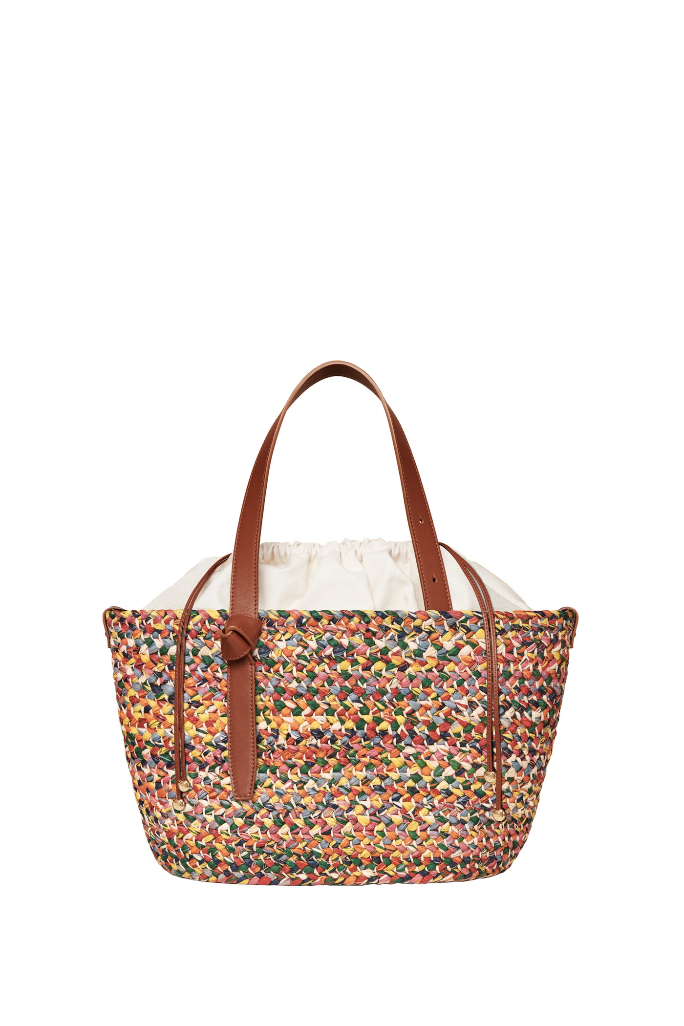 A Cesta Collective woven raffia tote with a multicolored design, brown leather handles, and white fabric lining—one of our unique female artisan handbags.