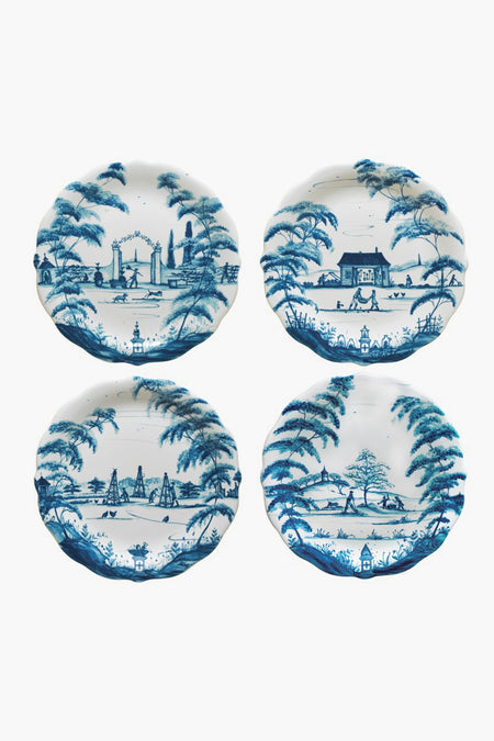 Set of four Juliska ceramic stoneware plates, each with a unique blue scenic design featuring landscapes, trees, and buildings. Decorative plates made in Portugal.