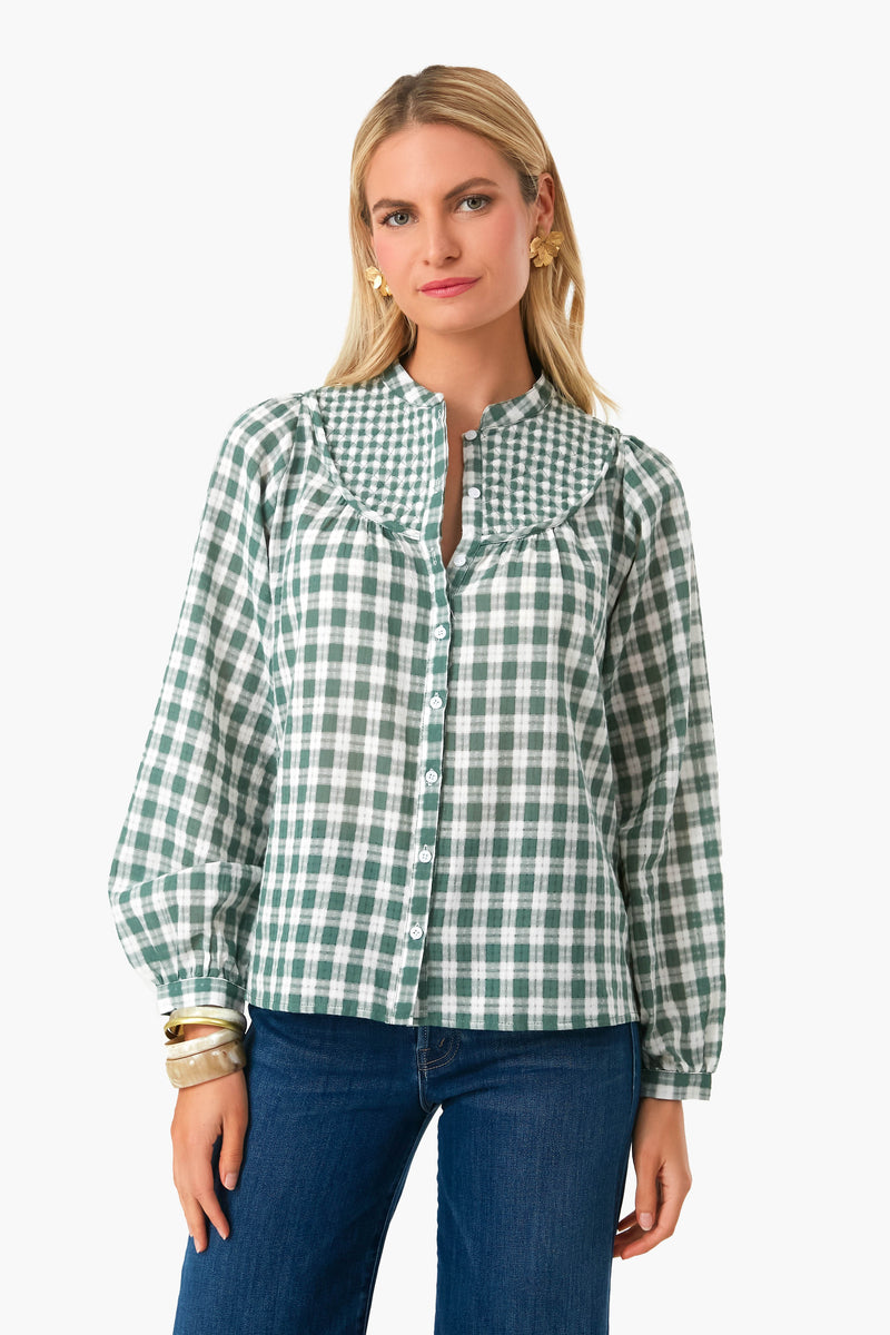 A woman confidently wears The Shirt by Rochelle Behrens Green Check Marissa Shirt with No Gape technology and blue jeans.