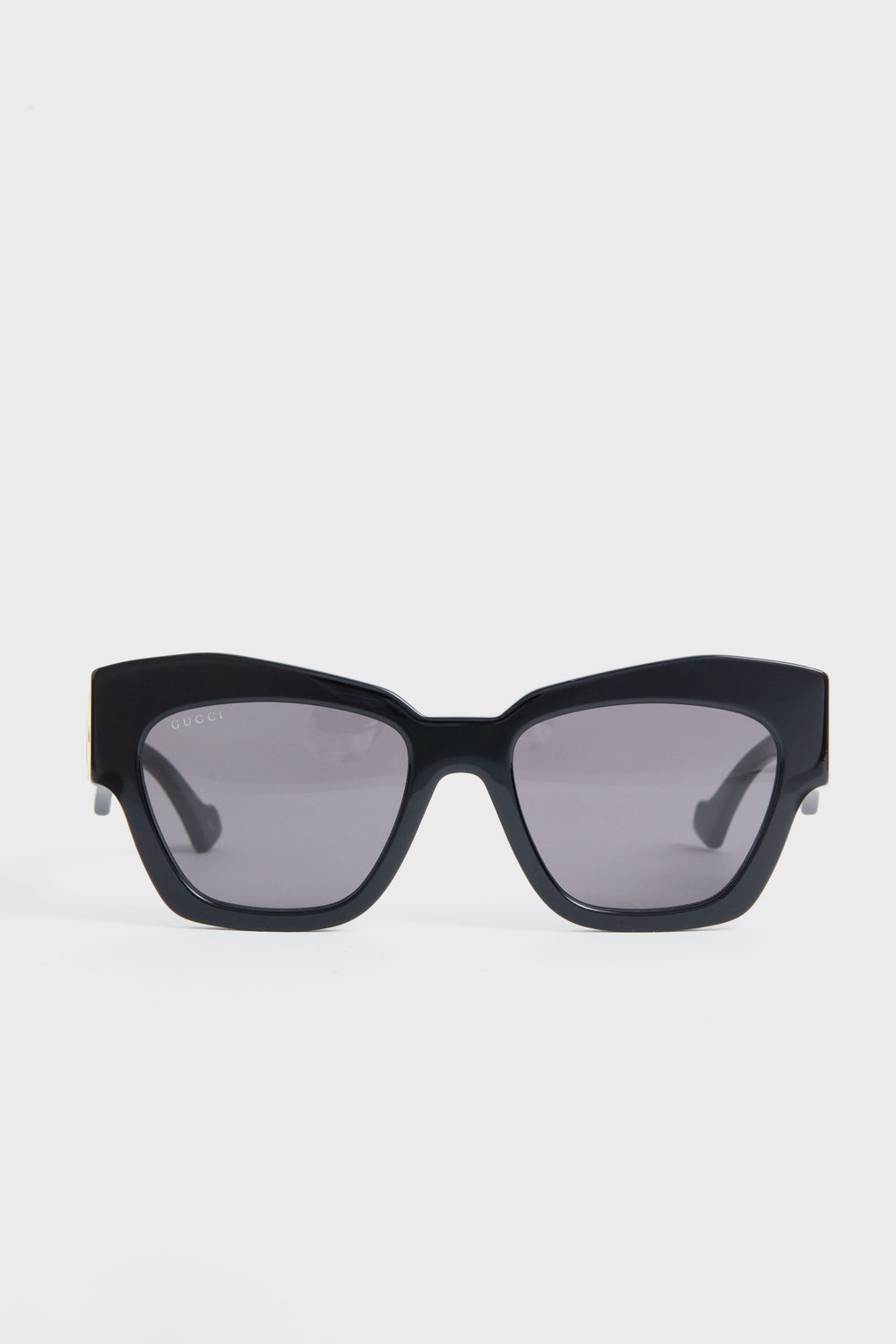 A pair of Gucci black rectangular sunglasses with dark tinted lenses, embodying luxury fashion.