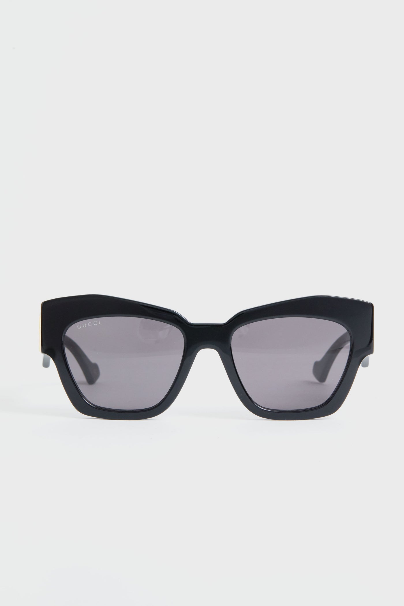 A pair of Gucci black rectangular sunglasses with dark tinted lenses, embodying luxury fashion.