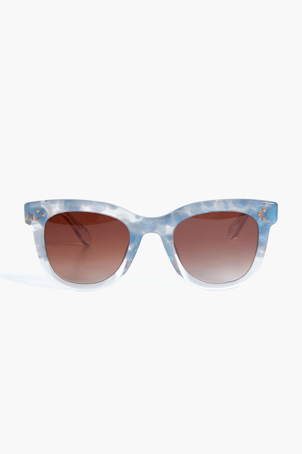 KREWE du optic’s Jena Sunglasses showcase blue and white marbled, handcrafted frames paired with brown gradient lenses that offer UVA/UVB protection.