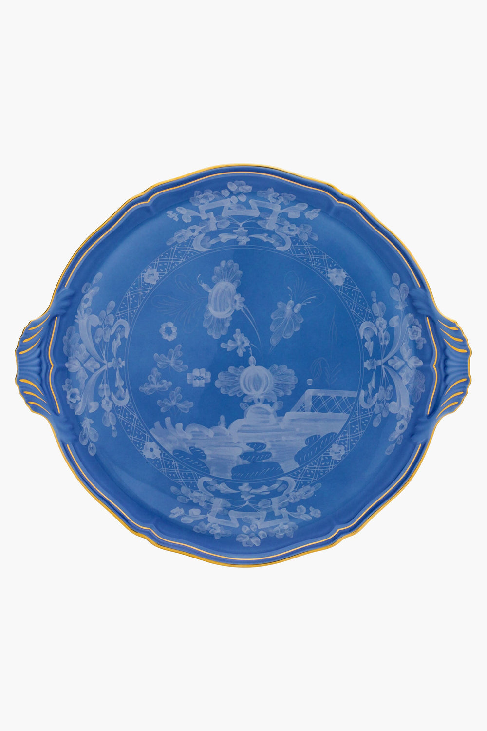 Handmade in Italy by Ginori 1735, this oval blue porcelain cake platter features white floral and landscape patterns, two handles, and a gold-trimmed rim.