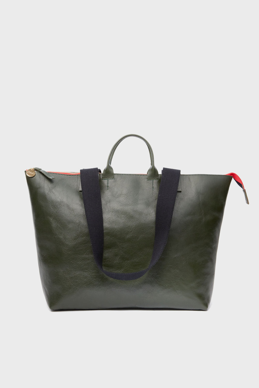 Clare V dark green Italian leather tote bag with short handles, black shoulder straps, red zipper pull, and secure zip closure.