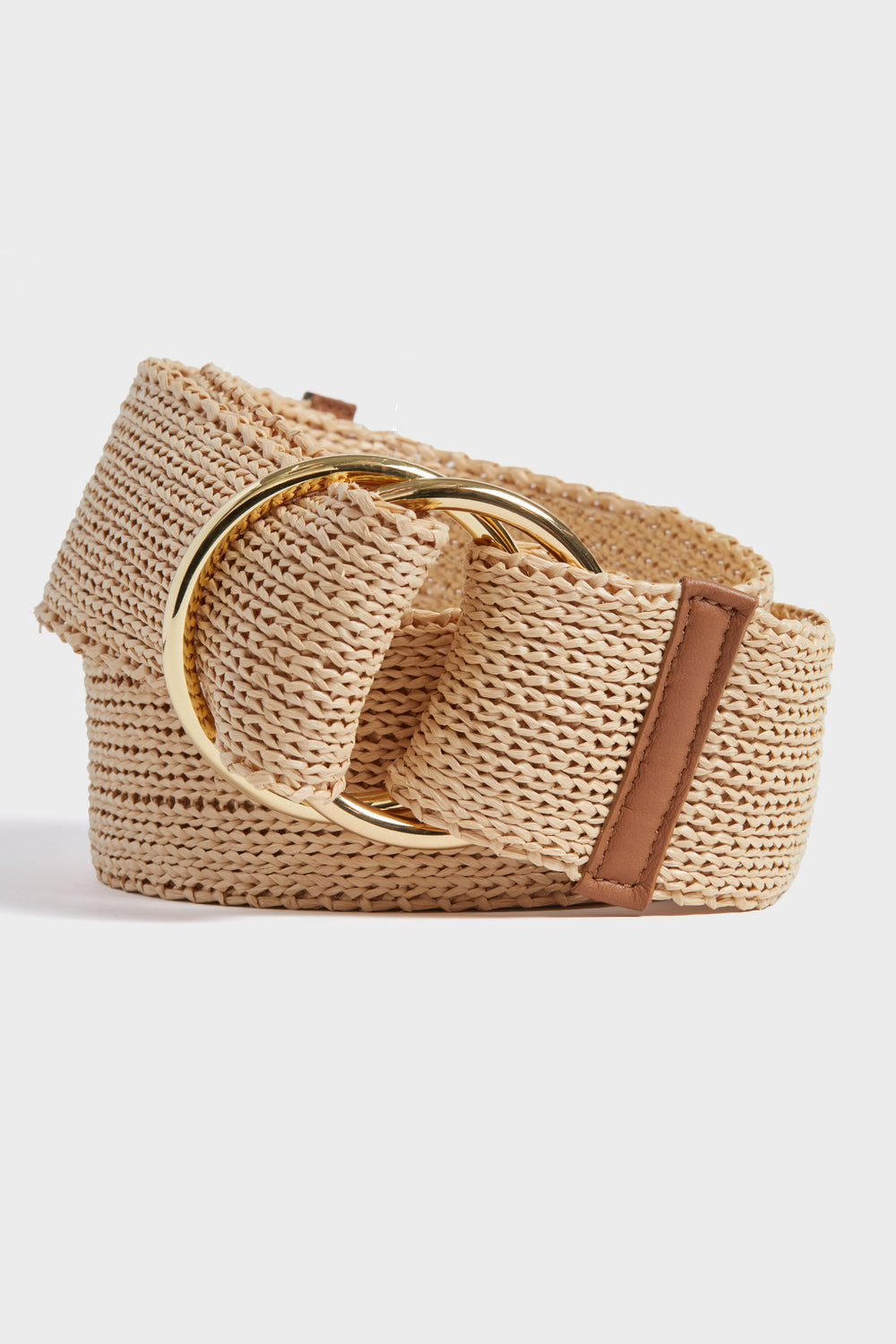 The B-Low the Belt beige woven straw belt features a large gold-tone circular buckle and a brown leather accent, perfect as a bohemian wrap belt.