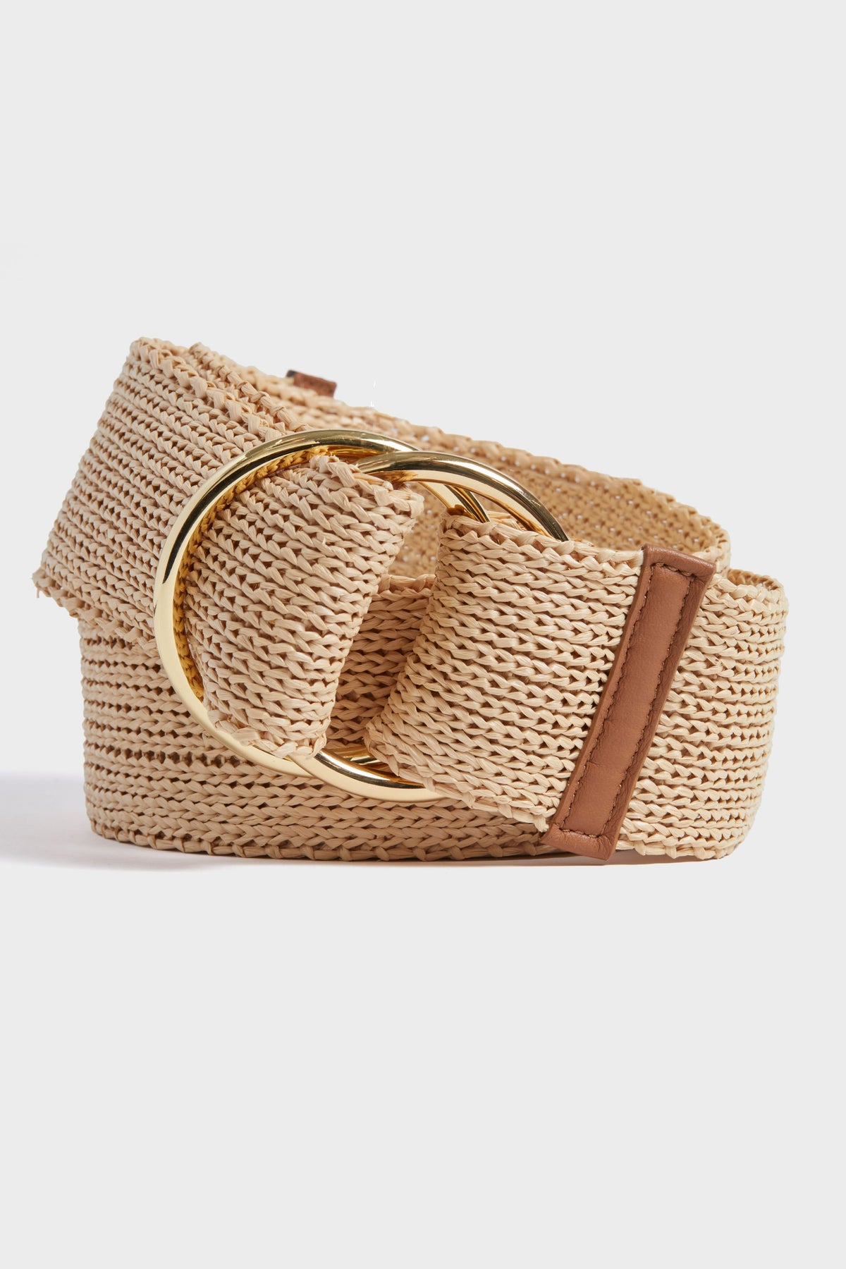 The B-Low the Belt beige woven straw belt features a large gold-tone circular buckle and a brown leather accent, perfect as a bohemian wrap belt.