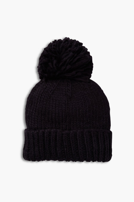 The Look by M black hand knit beanie features a folded brim and a large pom-pom on top.