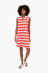A woman wears a KULE sleeveless red and white striped polo dress with a white collar, paired with white sandals and a gold bracelet.