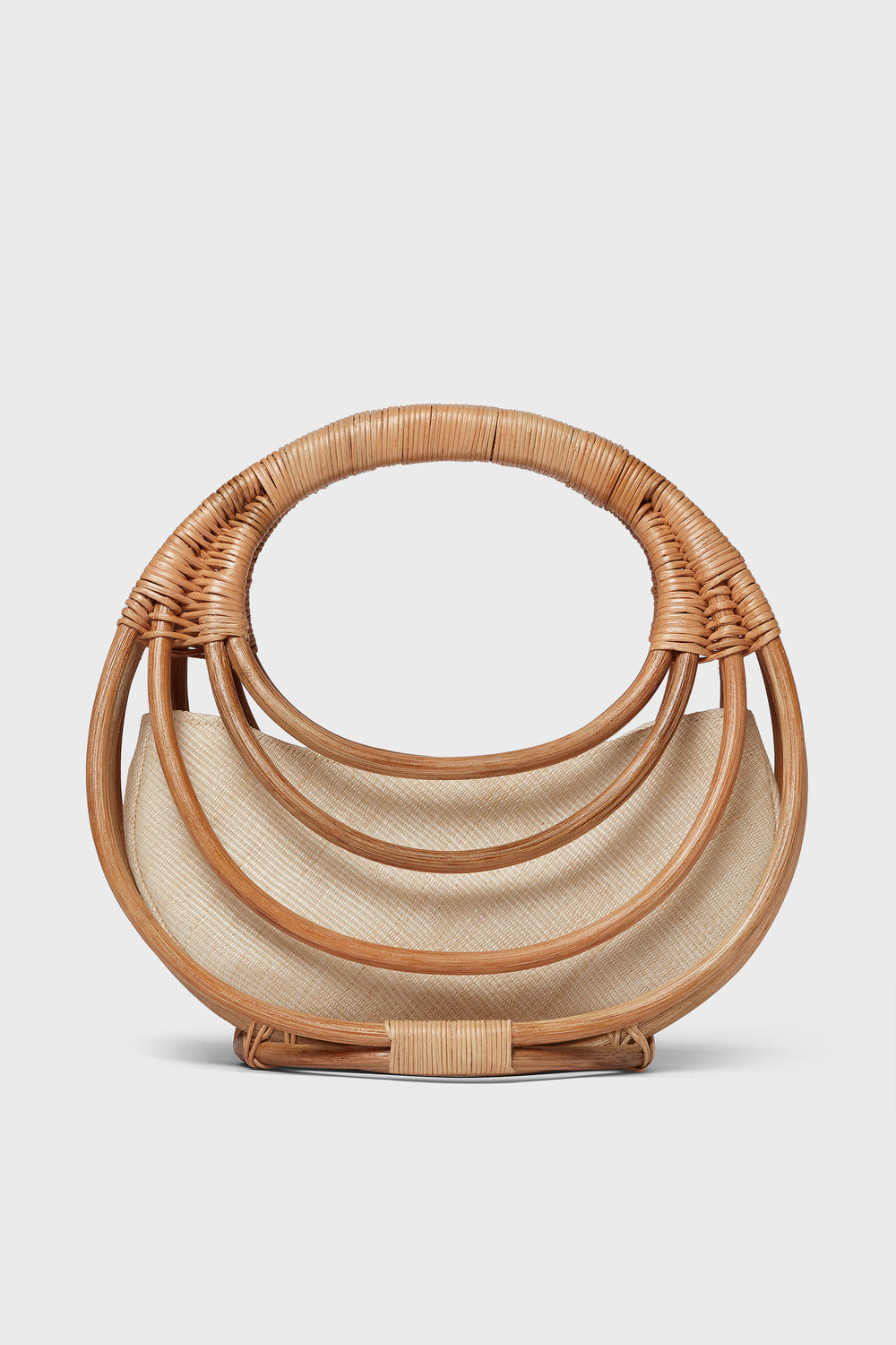 The Aranaz semi-circular handmade rattan bag features layered curved handles and a light fabric lining—an ideal choice for fans of artisanal accessories.