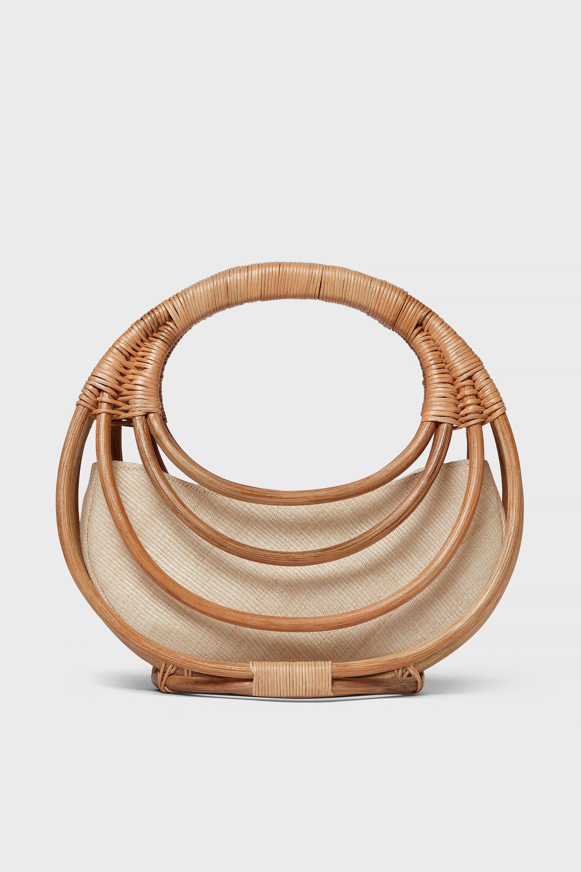 The Aranaz semi-circular handmade rattan bag features layered curved handles and a light fabric lining—an ideal choice for fans of artisanal accessories.