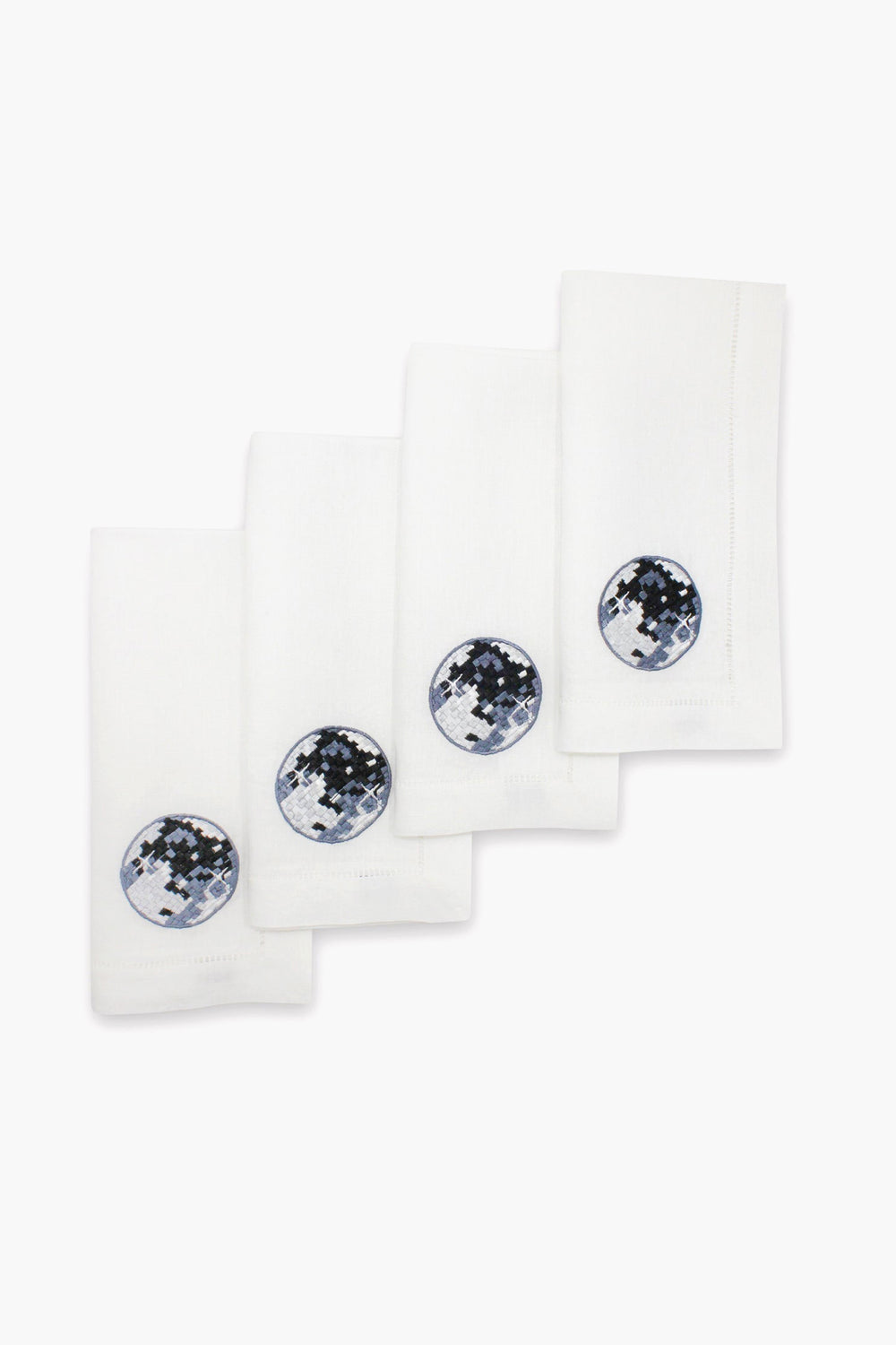 Set of four Chefanie white linen napkins, each with a circular embroidered patch in blue, black, and white—ideal disco ball dinner napkins to elevate any stylish tablescape.