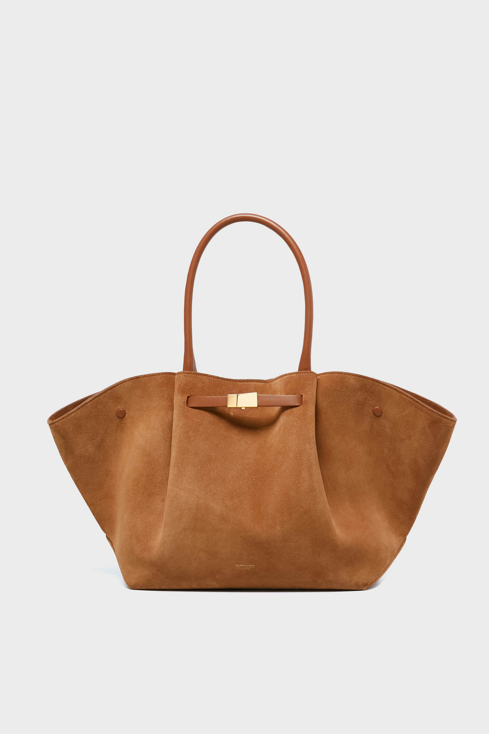A large brown suede tote bag by Demellier, featuring structured sides, rounded leather handles, and a gold clasp—an elegant addition to any luxury womens accessories collection.