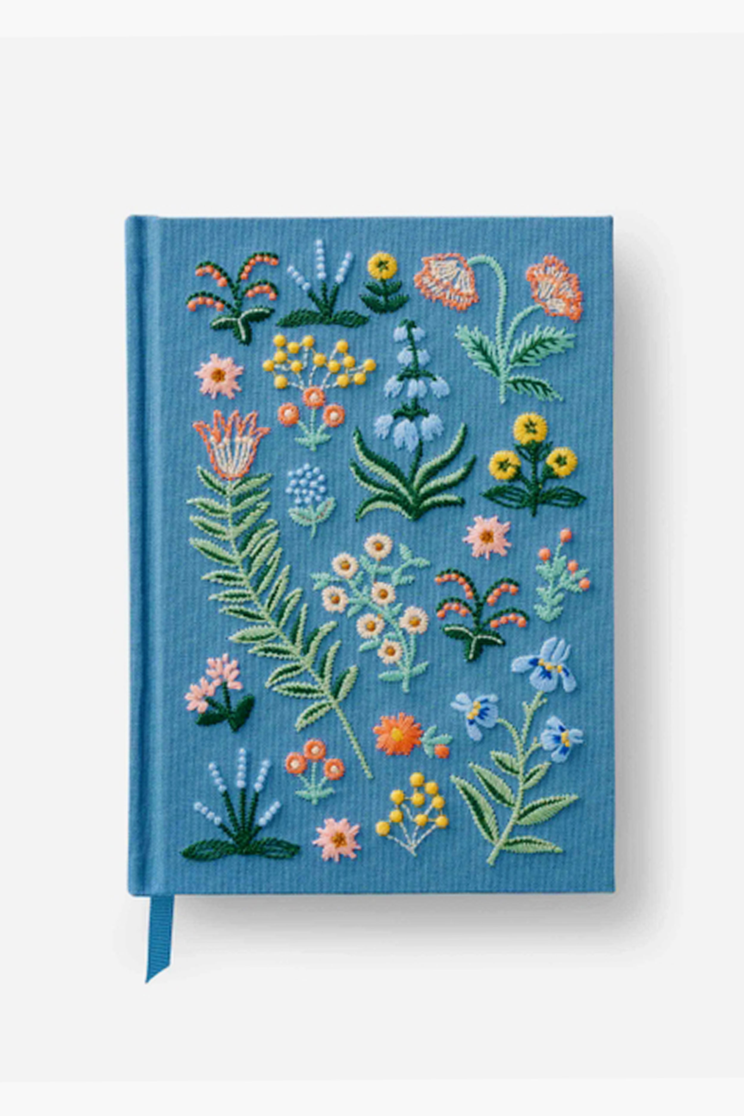 This blue hardcover journal by Rifle Paper Co. features embroidered vibrant floral designs and includes a matching blue ribbon bookmark.
