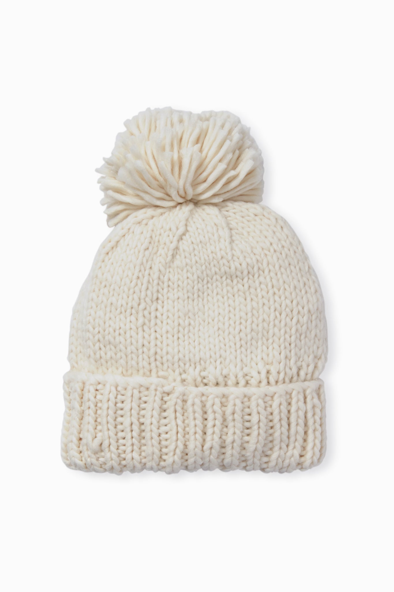 The Look by M hand-knit beanie features a soft cream color, a large pom-pom on top, and a cozy textured design.