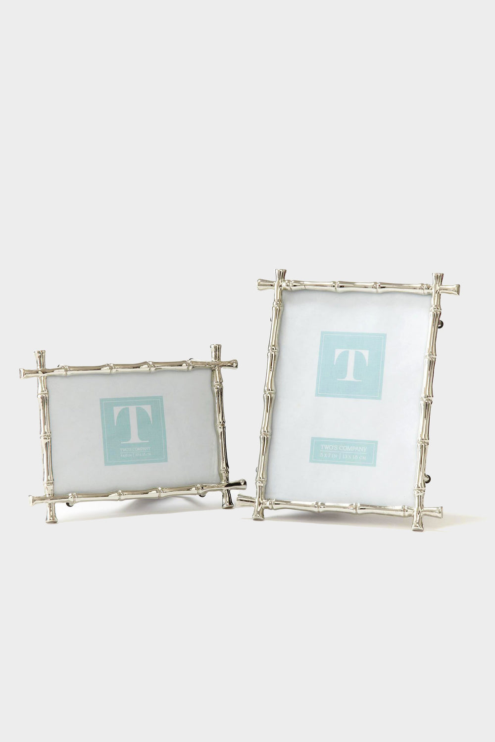 Two's Company presents two silver photo frames featuring a bamboo motif—one in a horizontal display and the other vertical—highlighting their distinctive design.