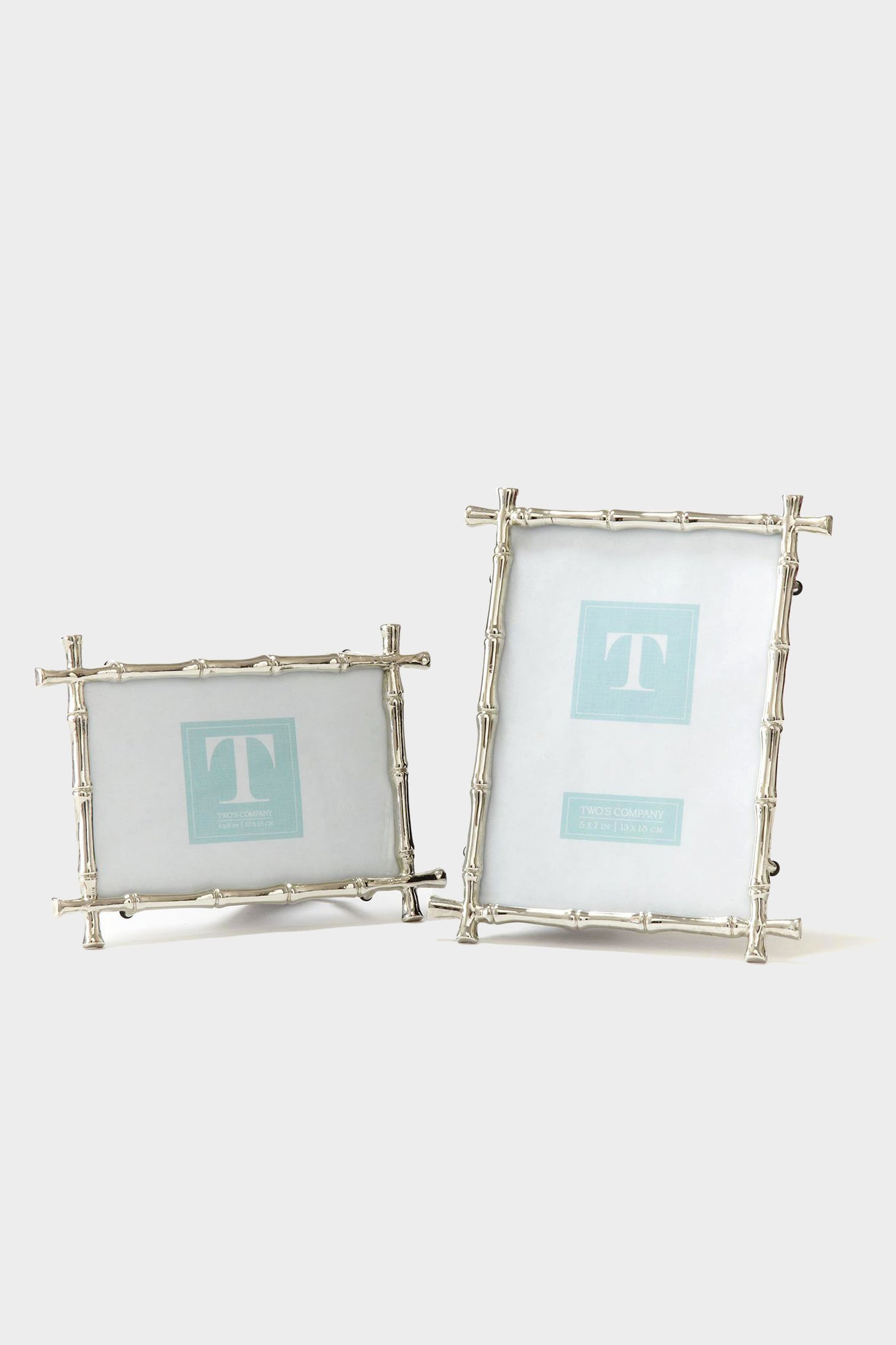 Two's Company presents two silver photo frames featuring a bamboo motif—one in a horizontal display and the other vertical—highlighting their distinctive design.