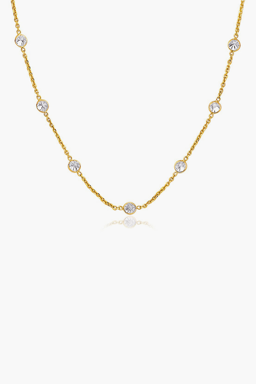 Tuckernuck Fine Jewelry’s 14k gold chain necklace features evenly spaced round white gemstones set in bezels—an everyday essential.