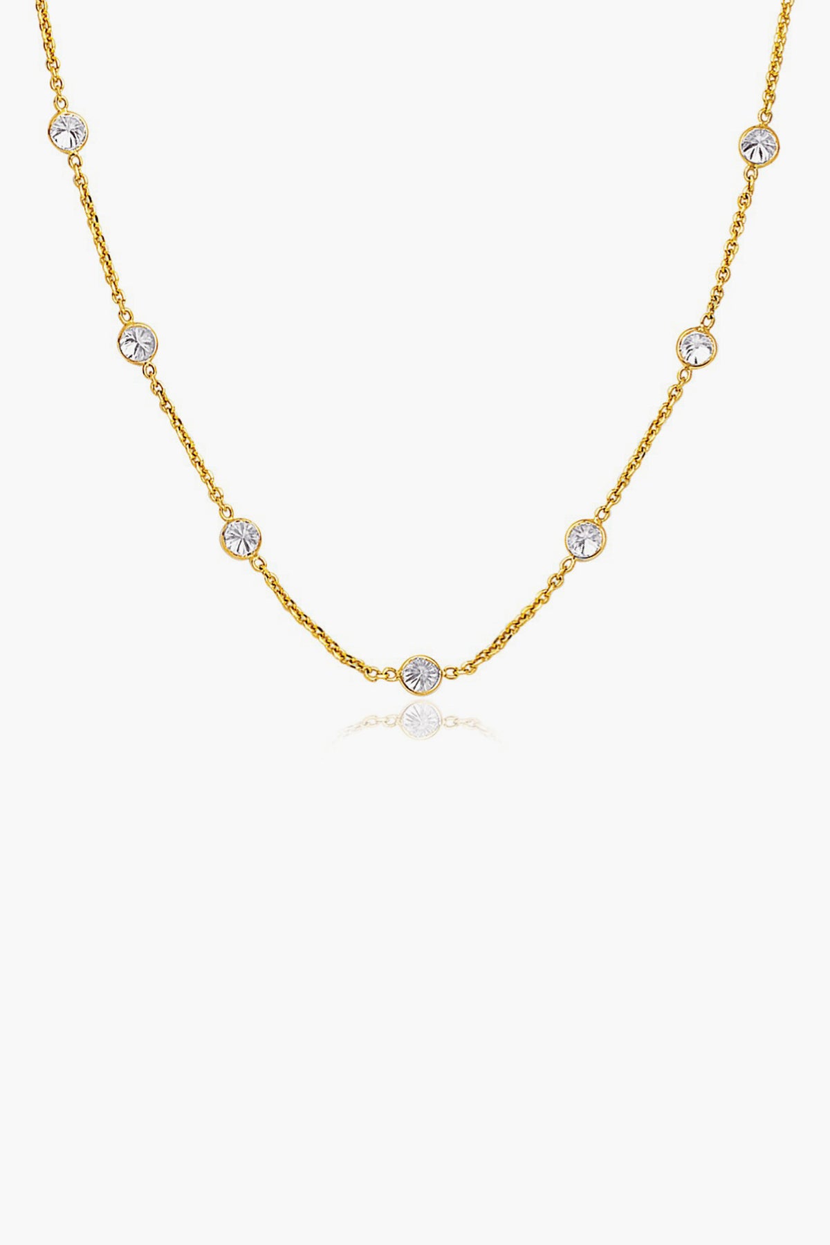 Tuckernuck Fine Jewelry’s 14k gold chain necklace features evenly spaced round white gemstones set in bezels—an everyday essential.